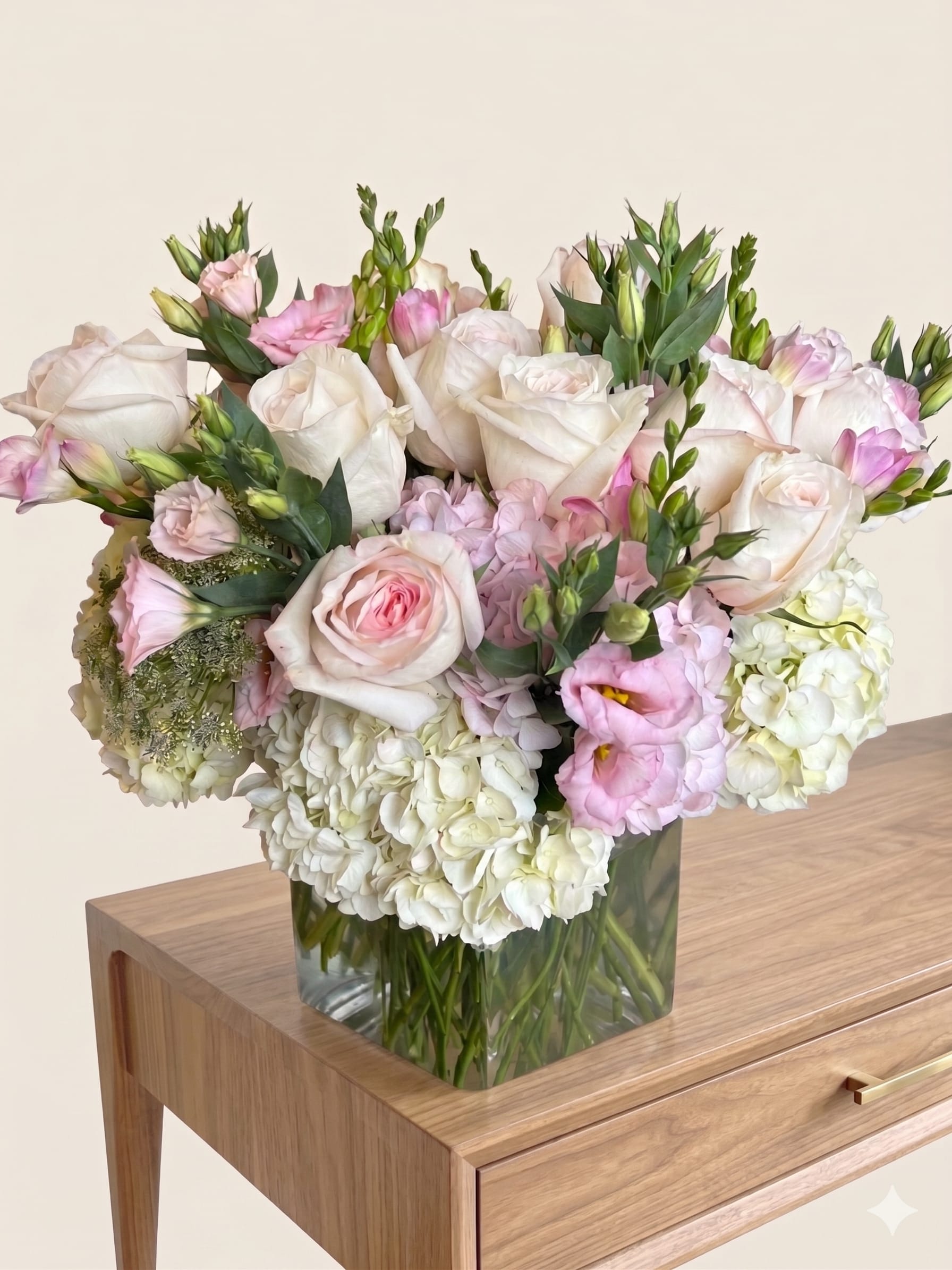 BP21 - Soft Pink Harmony - Vase arrangement with White, Pink and Green colour flowers.   It is a LARGE size in the picture.   Roses, Hydrangea, Freesia, Lisianthius and Queen's anne's lace are used for this arrangement.  Due to the availability of certain flowers and vases, substitutions might occasionally be necessary to assemble your bouquet.