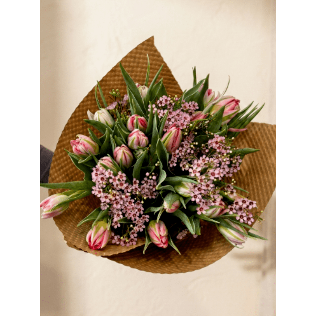 Pink tulip bouquet wrapped in brown paper