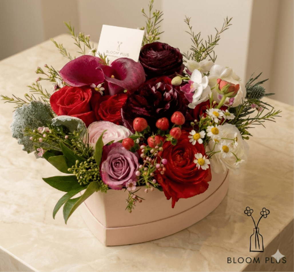 Heart-shaped box of red, pink, and white flowers