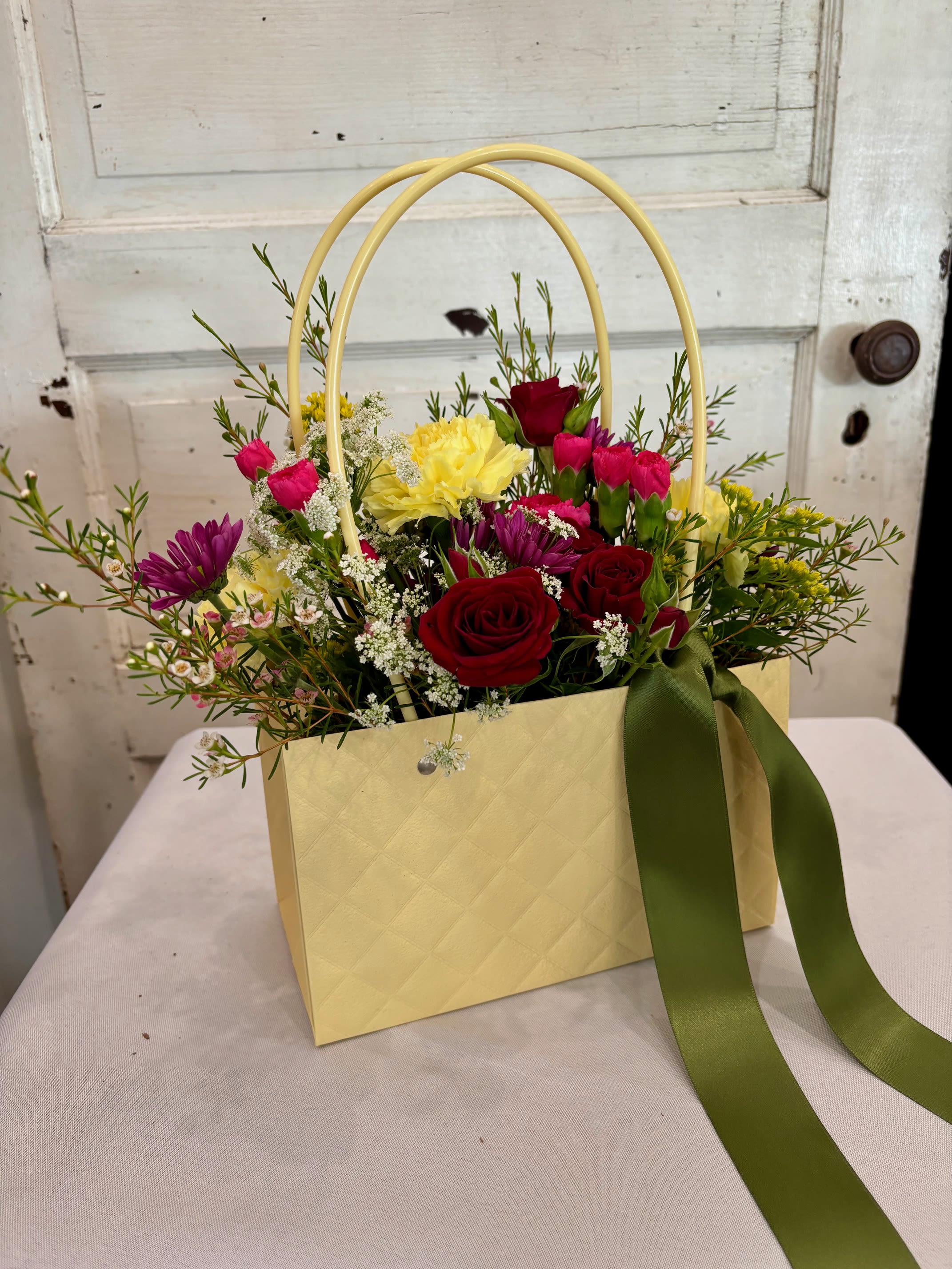 The Fresh Picked Purse - A 'handbag" full of fresh picked beauty. Designed with fresh seasonal blooms (each one is a little different). Made to feel like you just gathered them straight from the garden. (Purses come in a variety of colors)