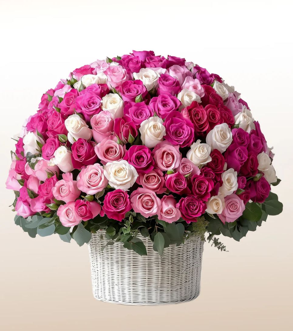 Large basket arrangement of pink, white, and magenta roses