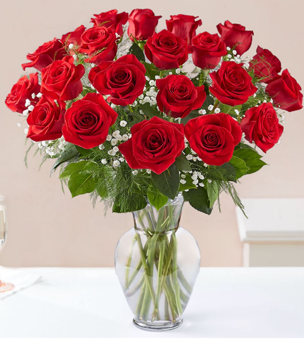 24 red roses in a vase  - Enjoy traditional red roses in a clear glass vase  With the touch of Petale de rose flowers  