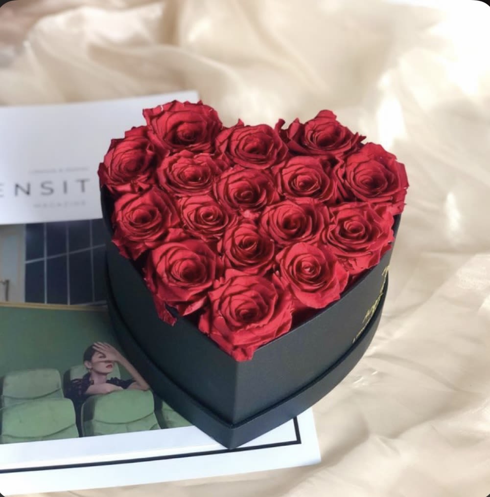 Heart-shaped box filled with red roses