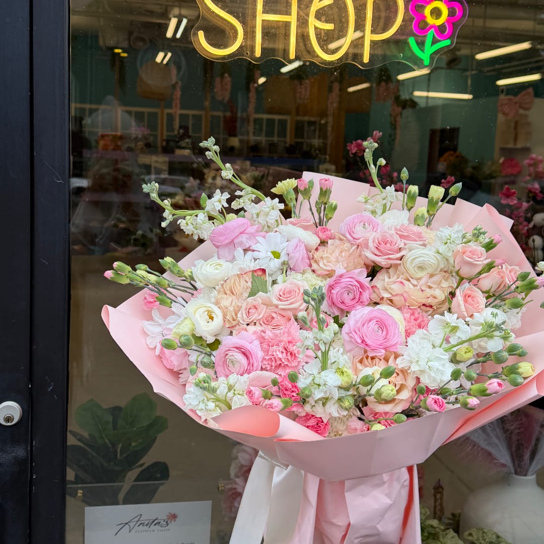 Pink and white mixed bouquet wrapped in pale pink paper