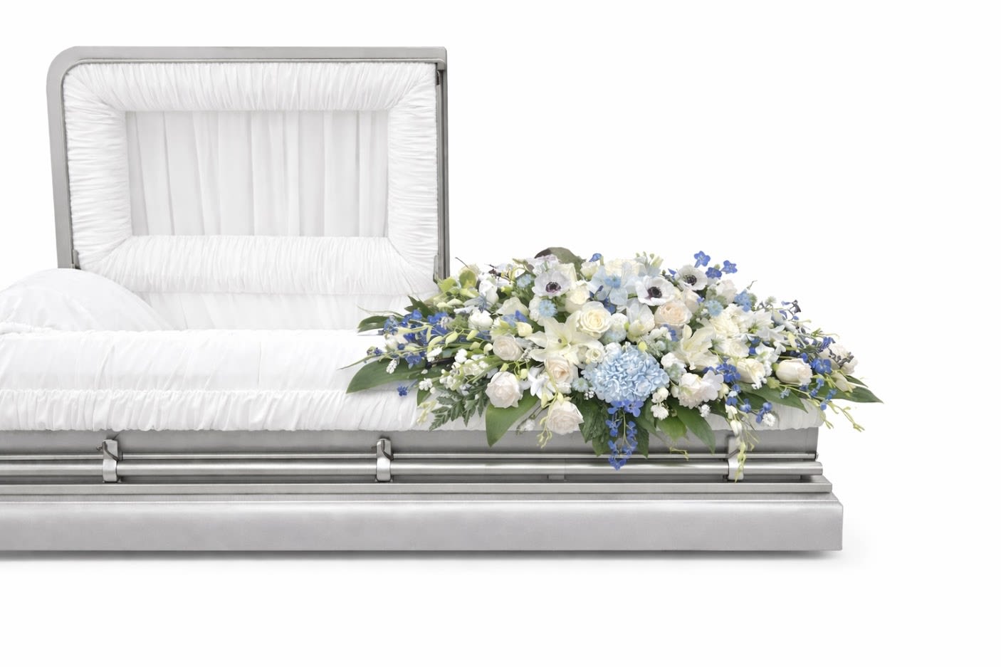 Blue Curl casket - An all Blue, white tribute, this half casket spray is pure in color and heart. Featuring a variety of white and light blue flowers and greenery, this elegant half casket spray compliments the beauty of life.