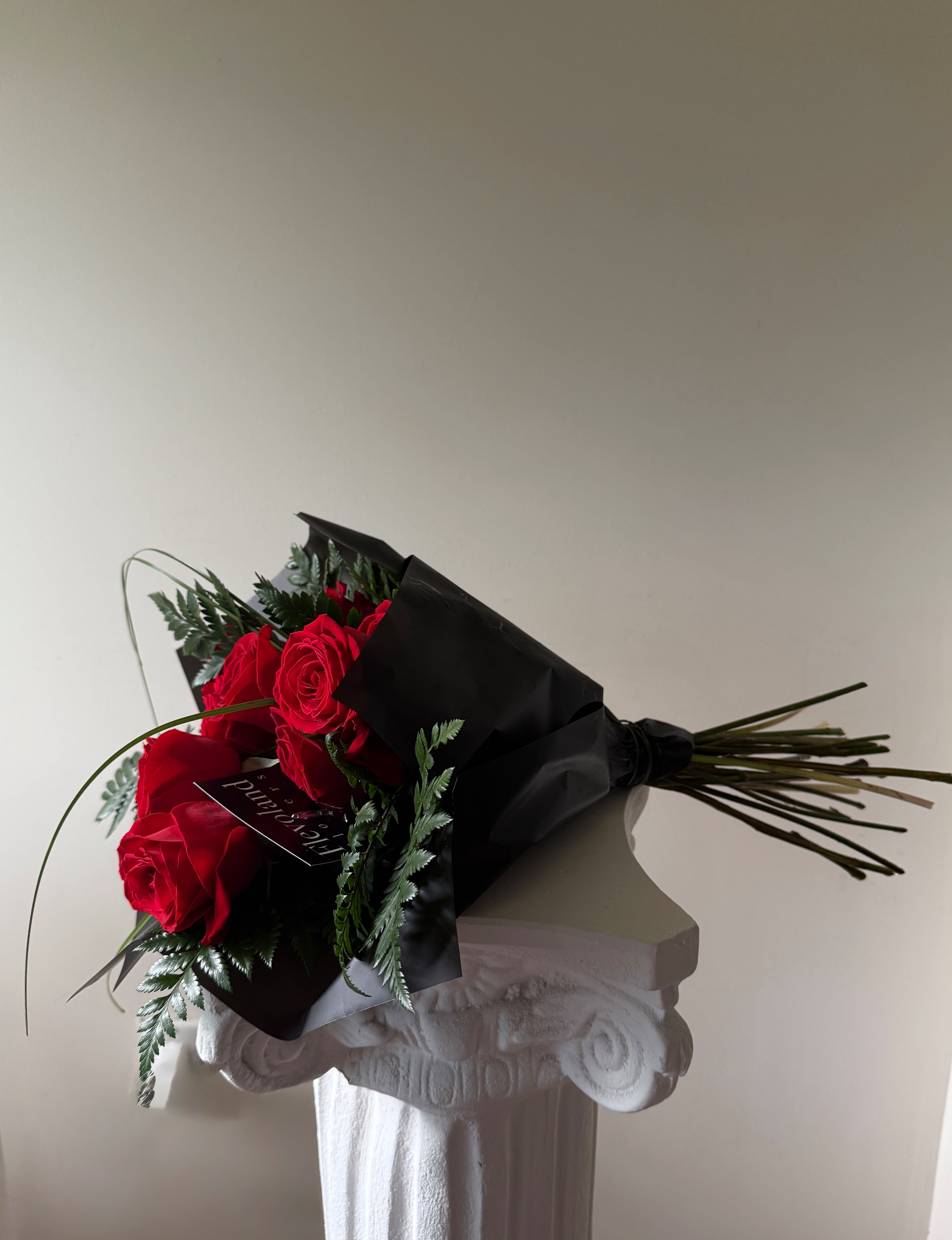 Classic Red, Refined - Premium Ecuadorian red roses, designed with a clean and refined finish.  Accented with fresh green foliage to add texture and balance, and wrapped in a neutral style that keeps the look modern and effortless.  A simple choice, elevated with quality materials and intentional design.  * Premium Ecuadorian red roses * Fresh green foliage * Larger blooms, long stems * Neutral, minimal wrap  Foliage may vary depending on daily availability, while maintaining the overall style and quality of the design.
