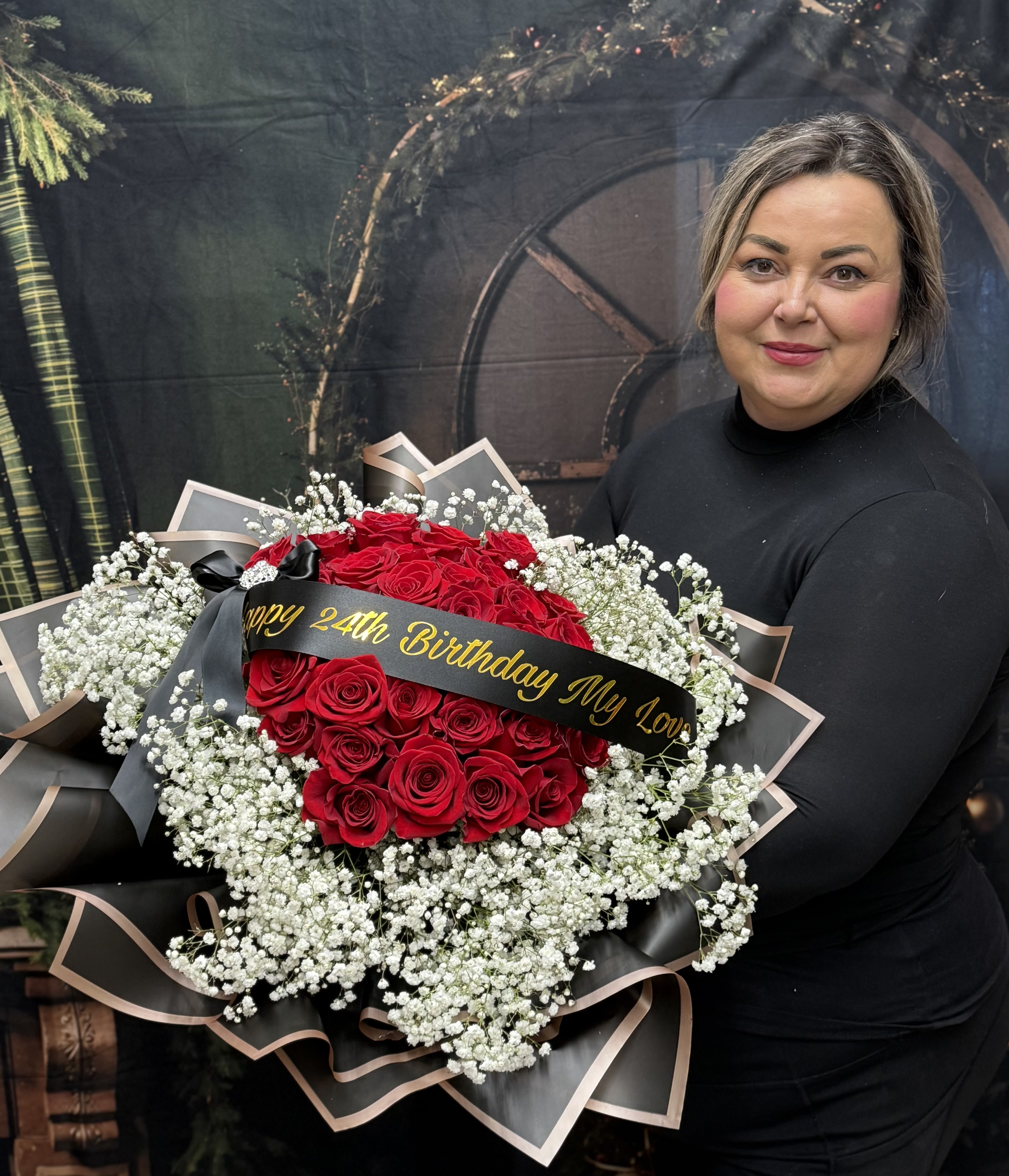 Large bouquet of red roses with white baby's breath and a birthday ribbon