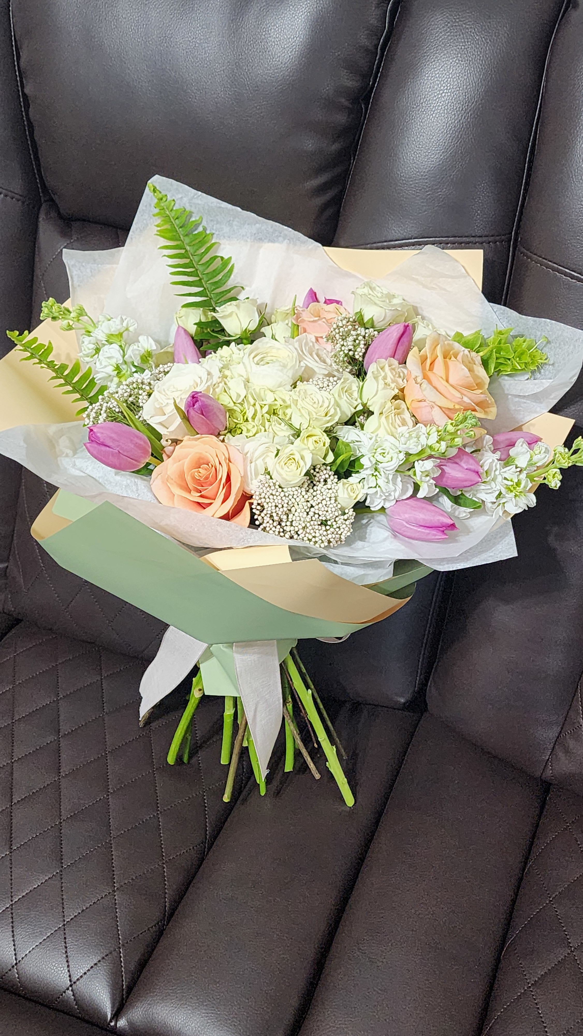 Radiant Joy - Radiant Joy is a vibrant and uplifting bouquet that bursts with color and energy. A stunning mix of roses, tulips and ranunculus and fresh greenery, creates a lively and joyful display. This bouquet brings sunshine into any room, filling the space with warmth and happiness. Perfect for celebrating special moments or brightening someone’s day, Radiant Joy is an expression of pure positivity and exuberance. 