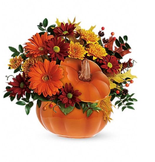 Country Pumpkin  - Country Pumpkin is simply and elegant fall arrangement in orange pumpkin with flowers like orange gerberas, chrysanthemums cushion gold, chrysanthemums daisy red, huckleberry, and fall leaves.