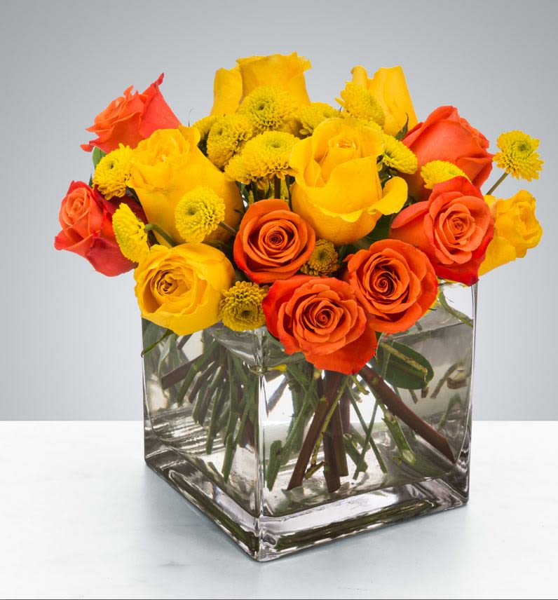 Cheer Up Buttercup by BloomNation™ - Yellow and orange roses come together for a fun and fresh arrangement. A great arrangement to send to both men and women as a gift, these flowers light up any room. Send this for admin professionals week, Cinco De Mayo, or a birthday.  Approximate Dimensions: 10"D x 10"H