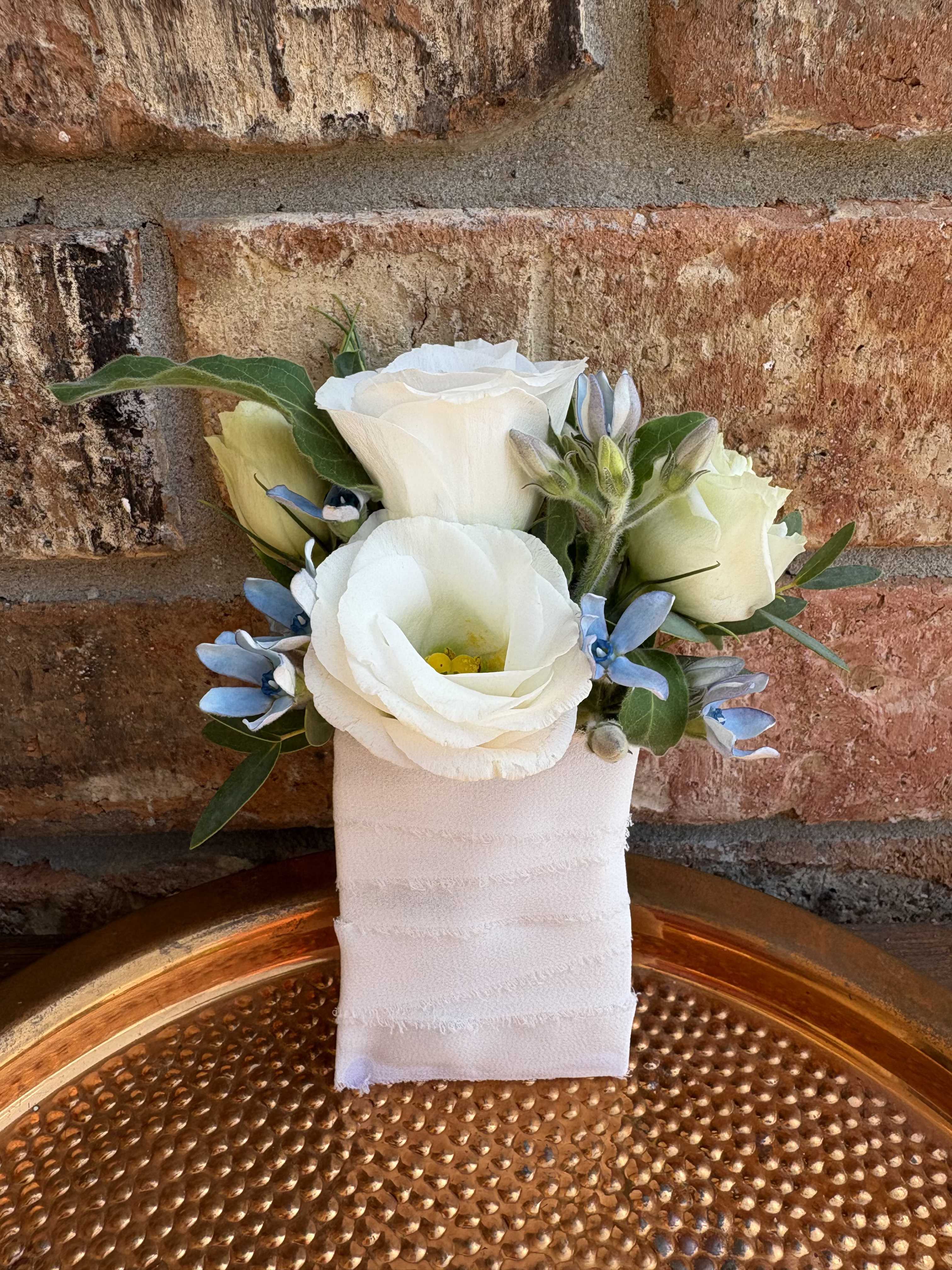 Pocket Party Boutonniere - Bring the party to your pocket with this playful, stylish boutonniere made just for your homecoming look. Each piece is fully customizable — choose your flower type and color palette to coordinate perfectly with your outfit or your date’s florals. From bold and bright to soft and subtle, this little bloom adds instant personality and good energy to your ensemble.