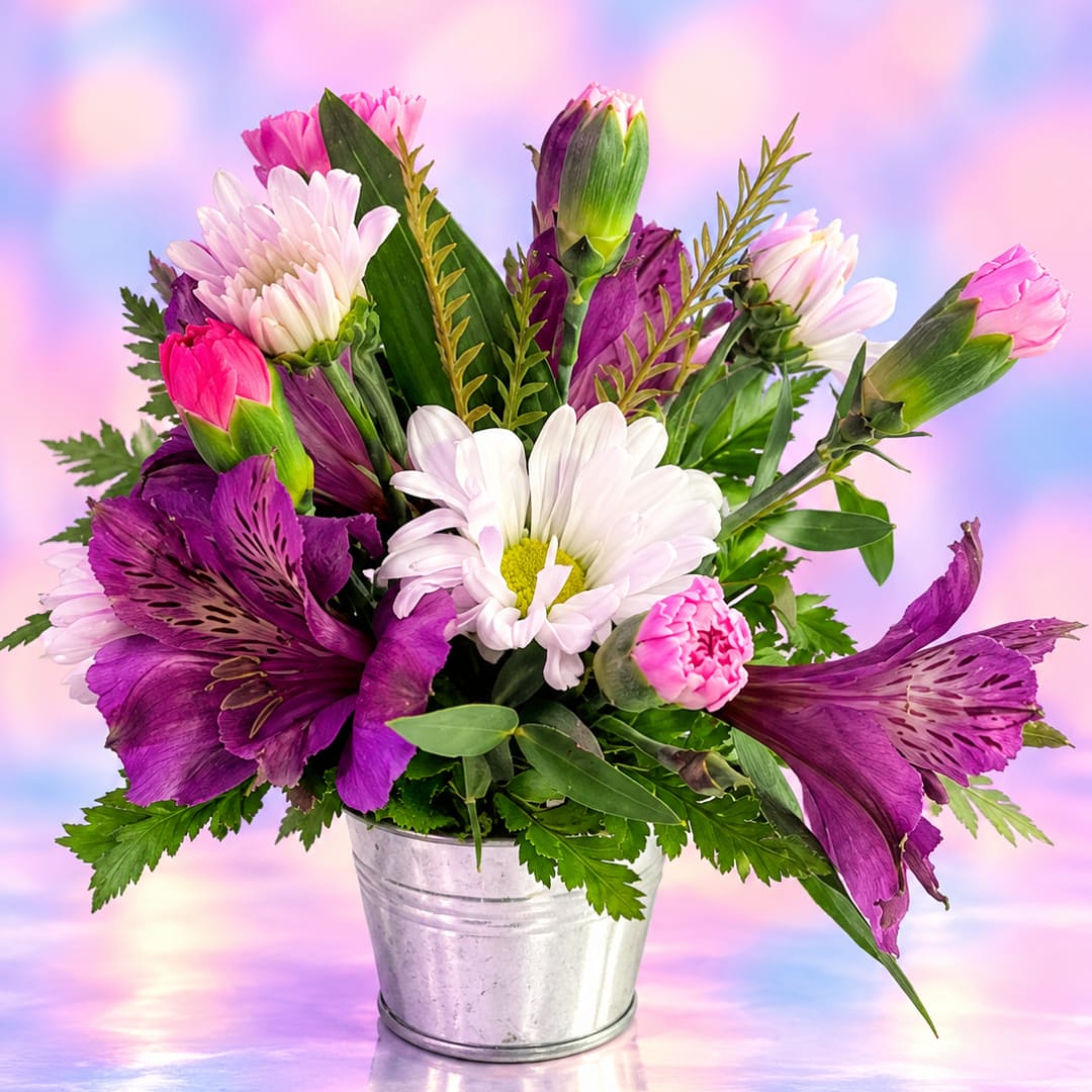 Purple and pink bouquet in a metal bucket with white daisies