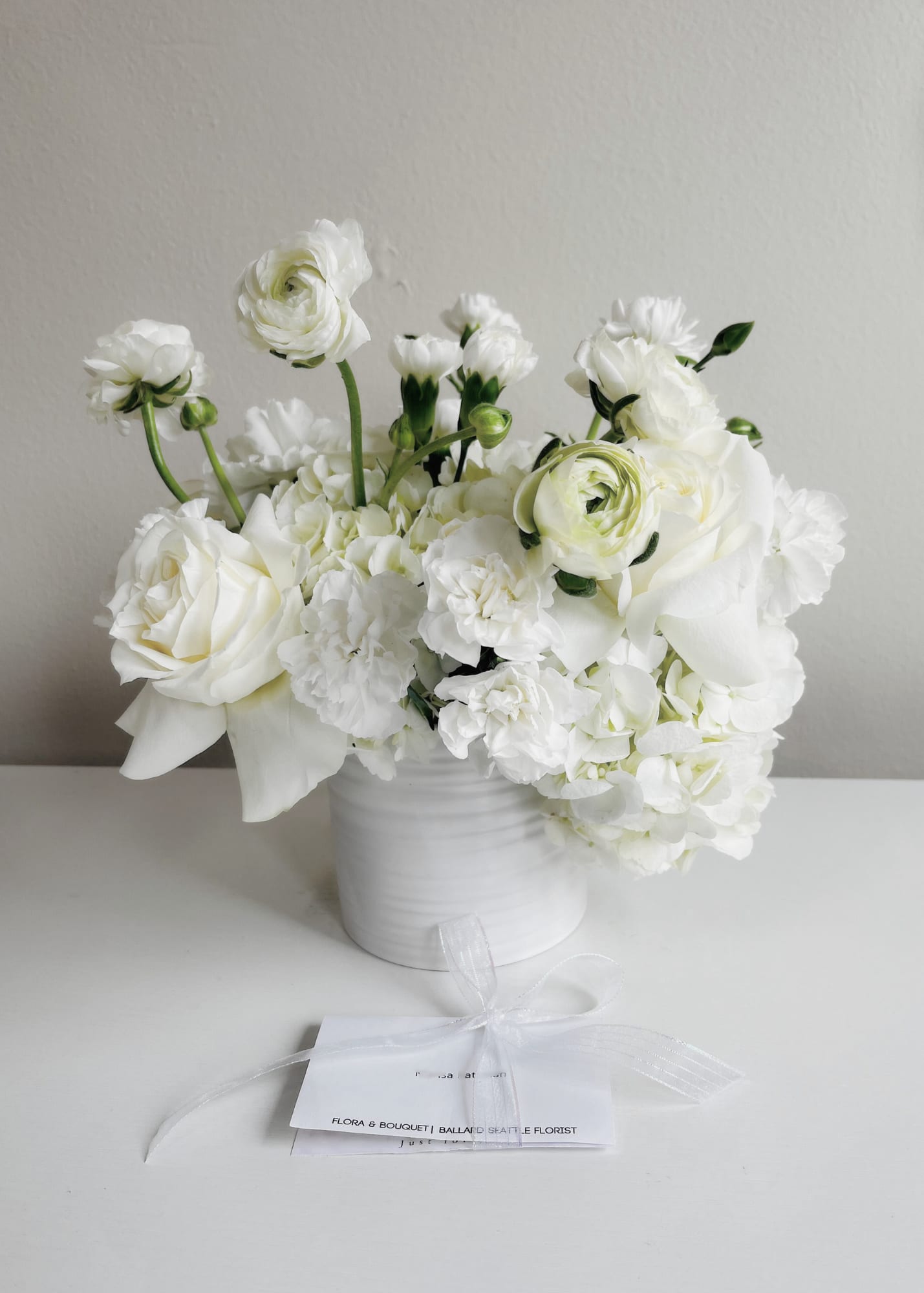Seattle's Signature Centerpiece - Seattle's Signature Centerpiece of pure white blooms set in an elegant container, creating a calm and timeless display perfect for weddings, centerpieces, or any space loved by natural color enthusiasts.