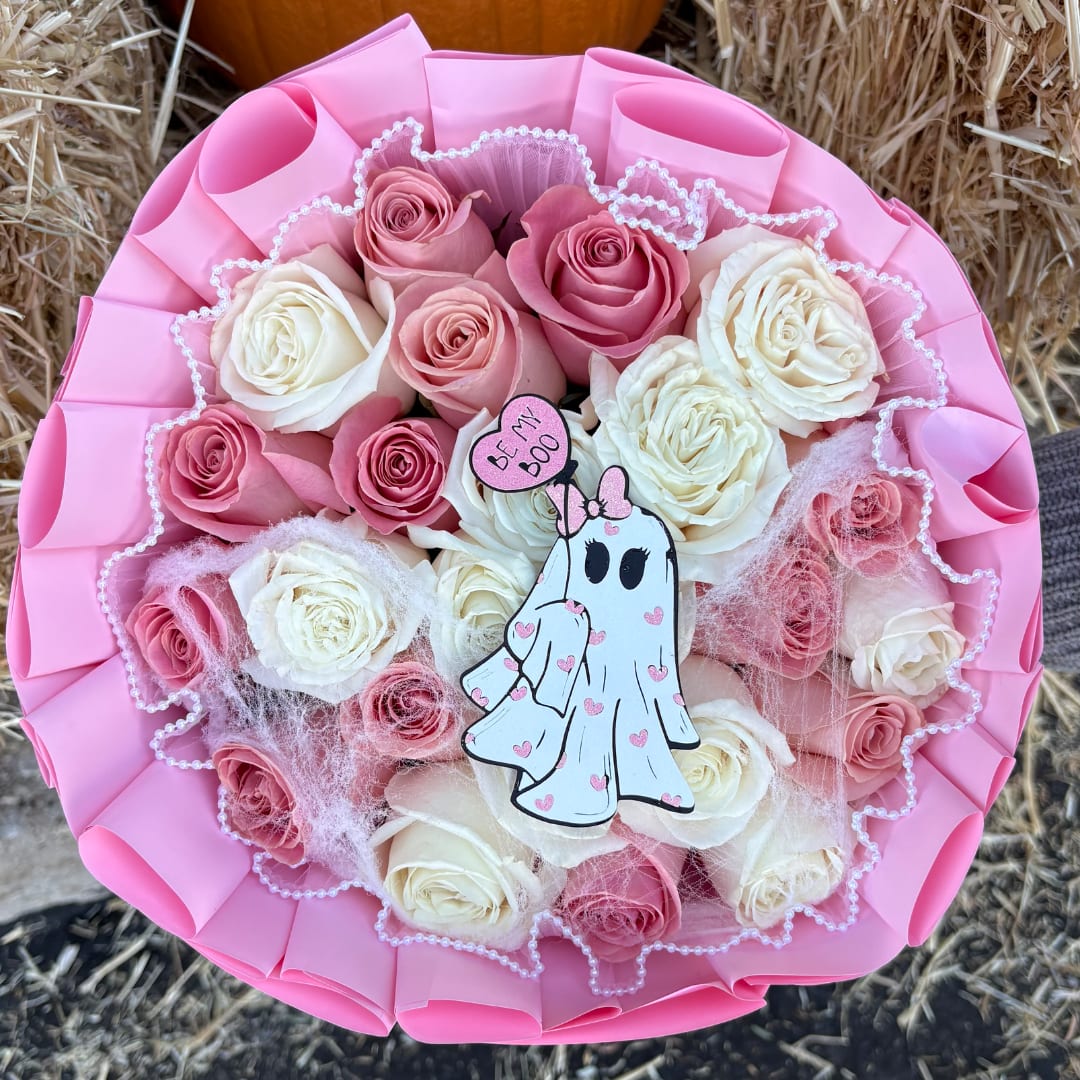 Pink and white rose bouquet with a ghost topper and pink wrapping