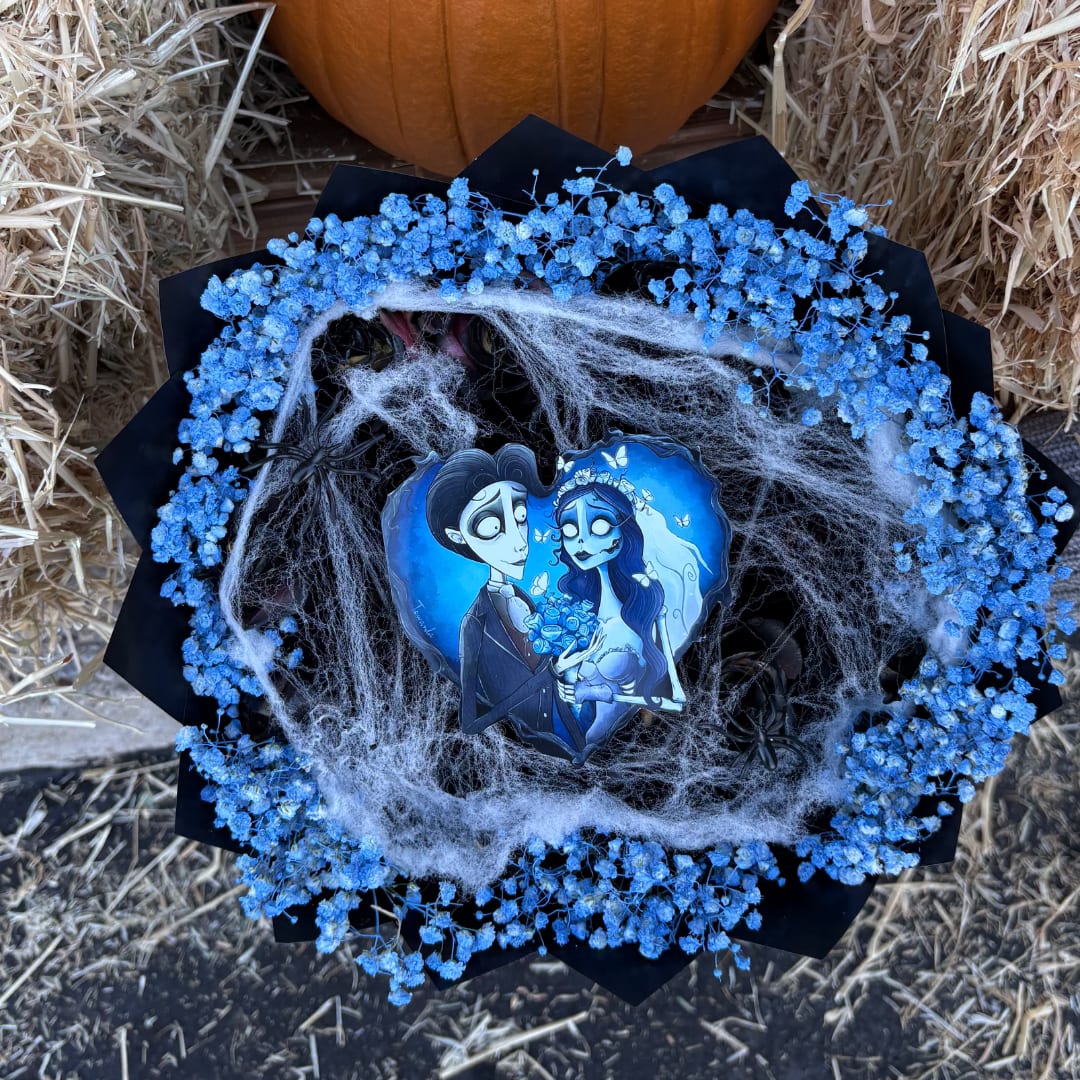 Blue baby's breath bouquet with a Halloween-themed topper