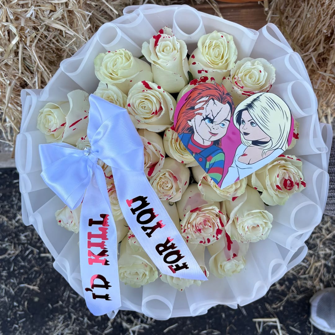 Bouquet of cream roses with a white ribbon and heart topper