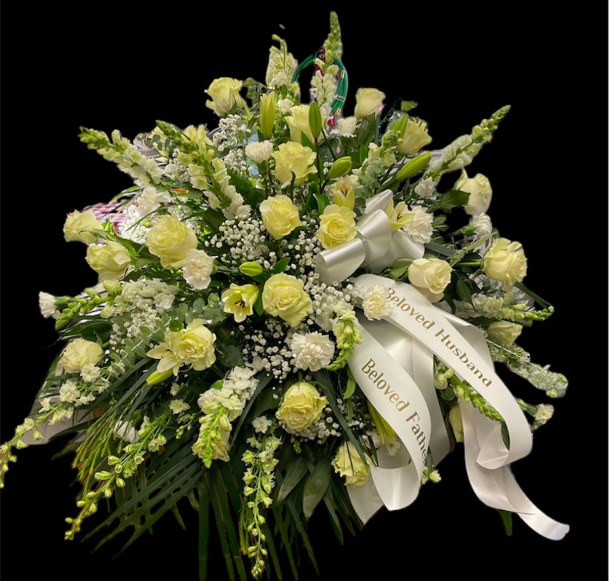 Everlasting Love &amp; Light - Elegantly Designed: Handcrafted with meticulous care, this full and abundant spray creates a comforting blanket of blooms across the casket, expressing reverence and deep respect. Symbolic Floral Palette: Featuring serene white roses, lilies, and delicate baby's breath, intertwined with warm yellow accents of roses, symbolizing purity, peace, and eternal love, alongside bright memories and enduring friendship.