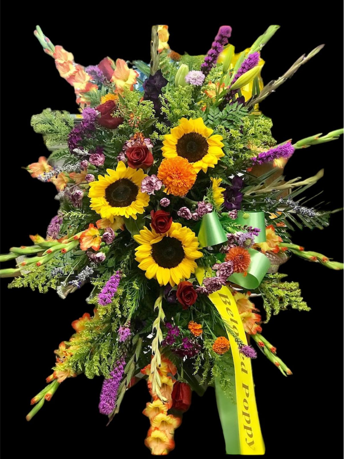 Large mixed bouquet with sunflowers, red roses, and purple accents