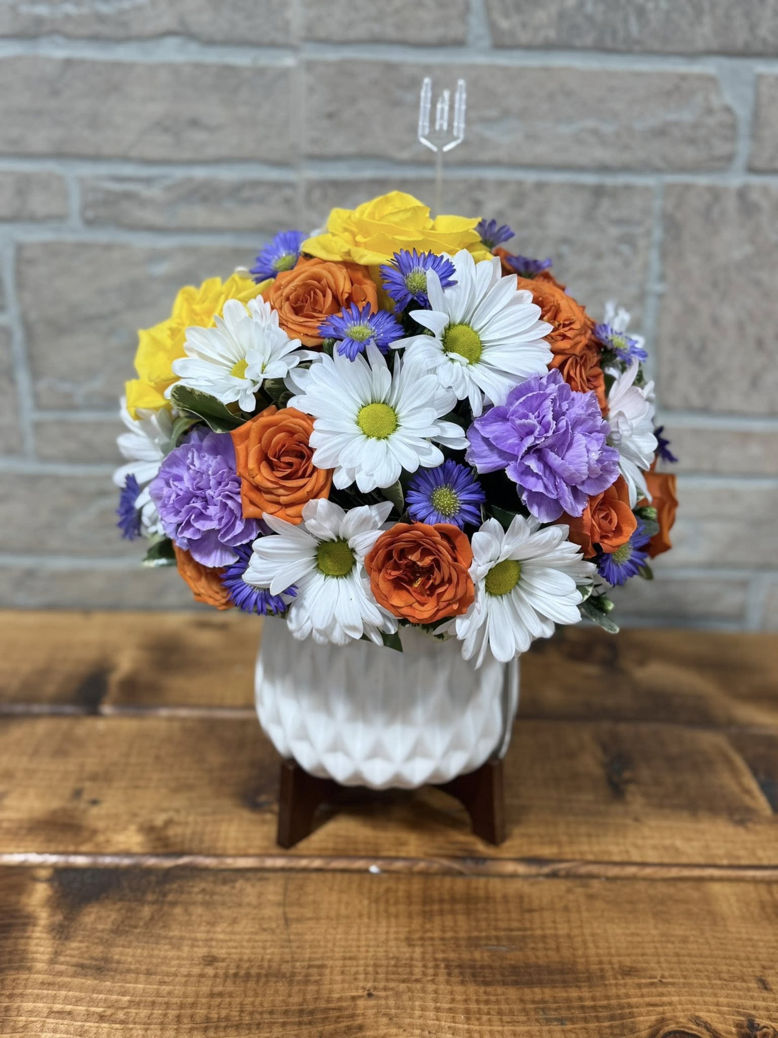 Blooming Modern Bouquet  - Sleek, stylish, and full of life, the Modern Bloom Arrangement features a vibrant mix of fresh, seasonal flowers beautifully arranged in a crisp white ceramic container. The clean lines and contemporary design make it a perfect gift for modern homes and offices, while the lush blooms add a burst of color and joy. Ideal for birthdays, celebrations, or just because, this arrangement effortlessly blends elegance with a fresh, uplifting feel.