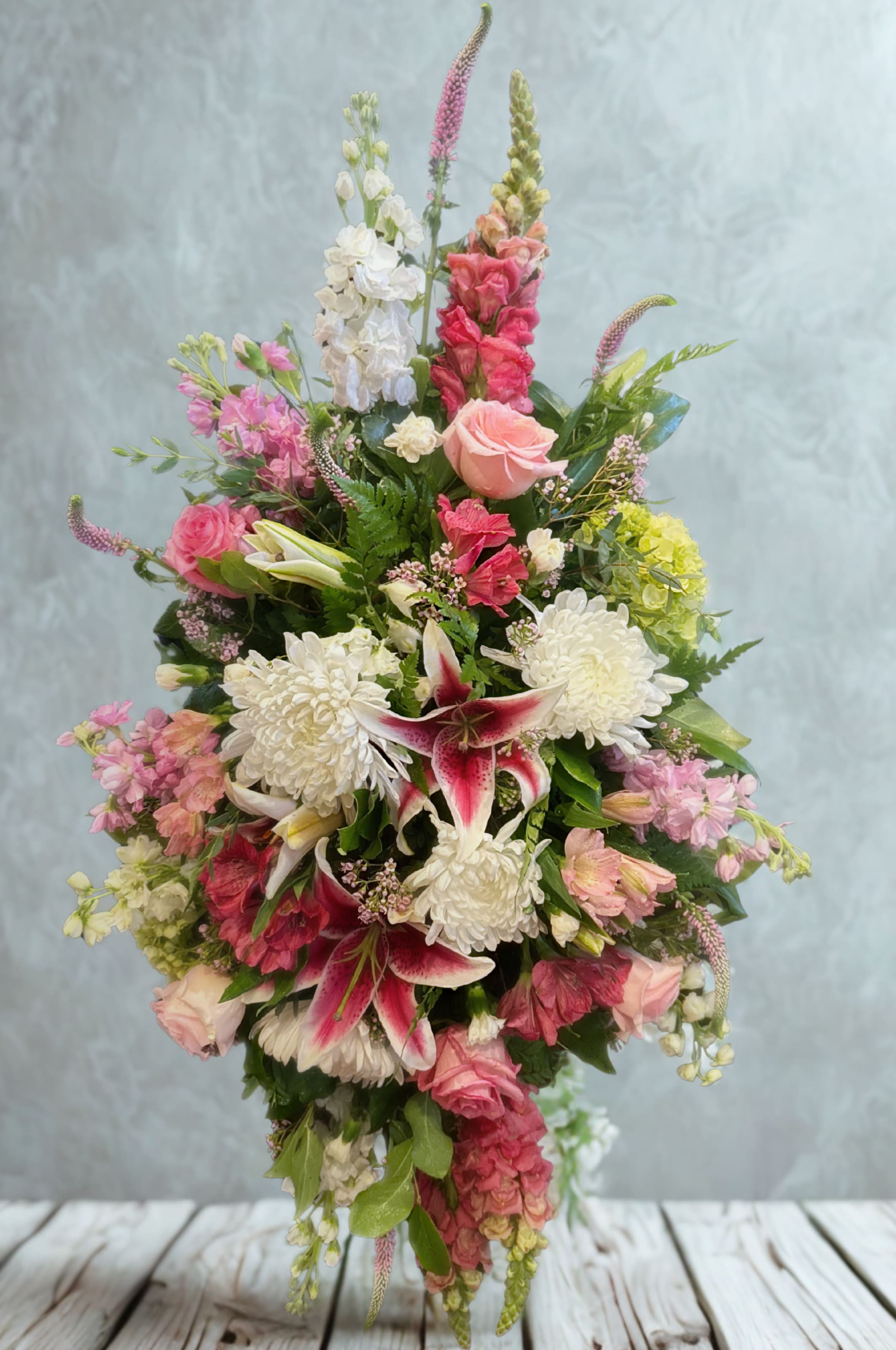 Tall bouquet of pink and white flowers with lilies and roses