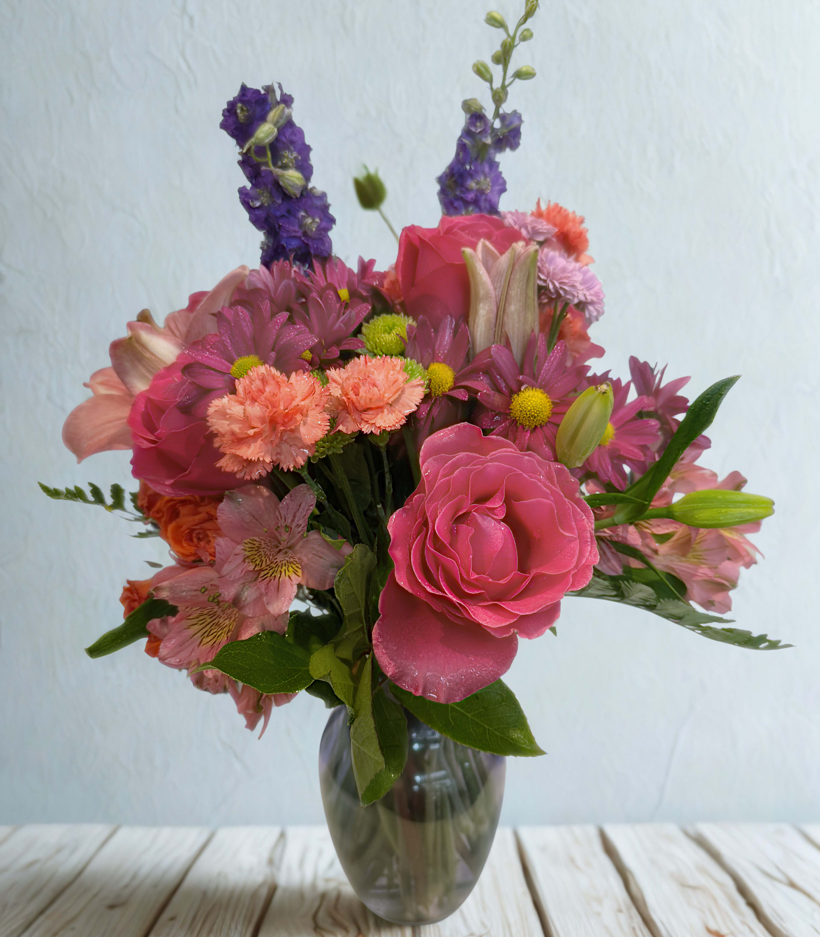 Pink and purple mixed bouquet in a glass vase
