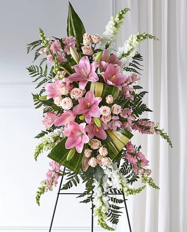 Tall pink and white floral standing spray on an easel