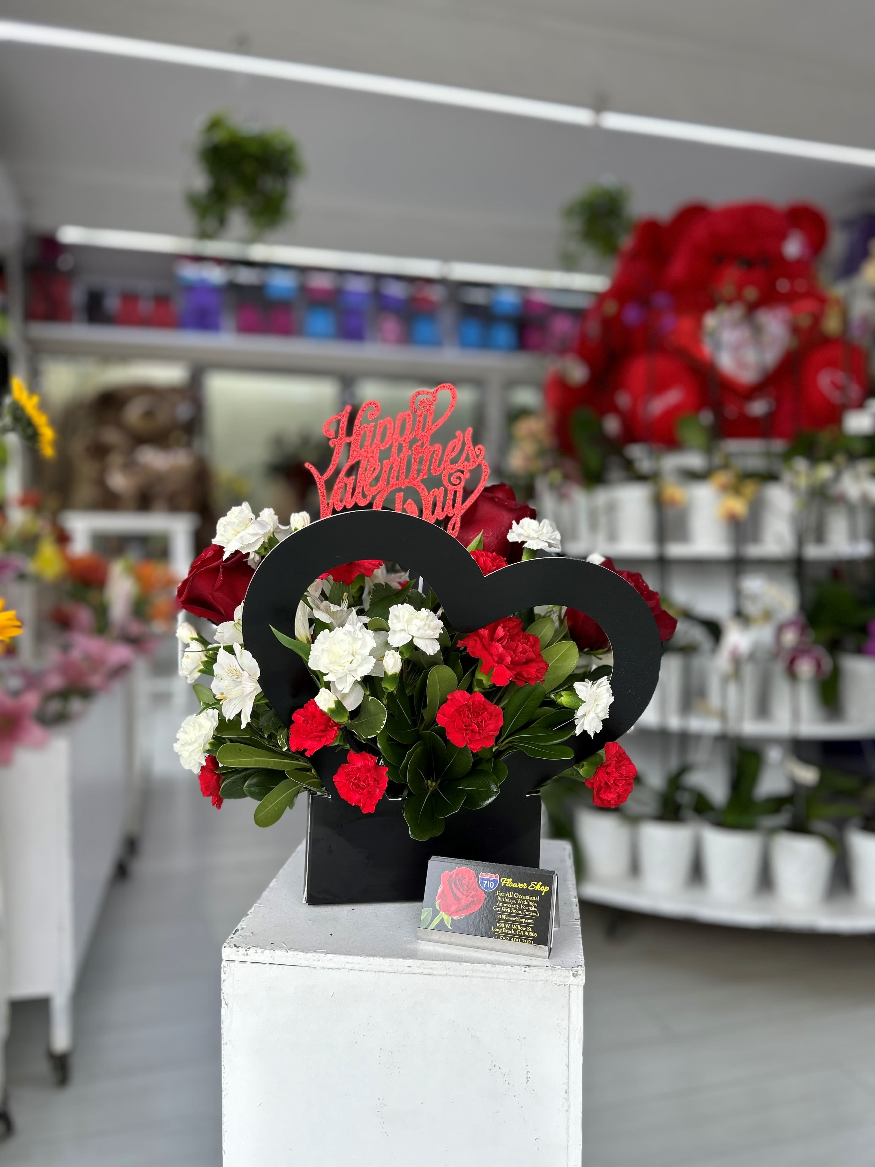 Black Heart Box Arrangement  - A cute black heart box arrangement with beautiful flowers! Comes included with valentines day sign! Heart Box comes in Pink, Black, and White with a mixture of flowers. If you'd like a specific color please leave note in instructions! Substitutions: If some flowers and/or the vase are not available there will be minor substitutions.