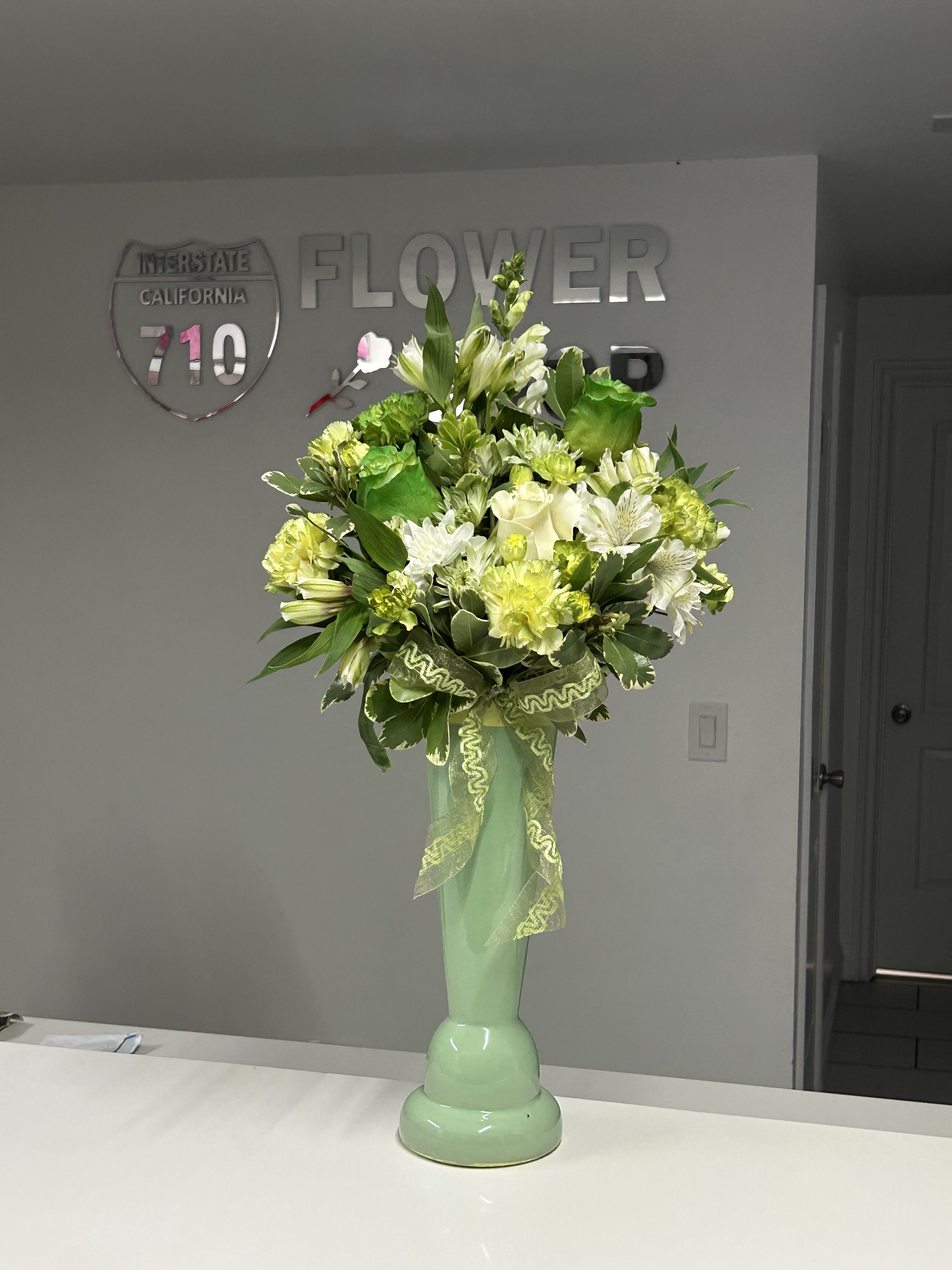 Green Dream - Green Dream is an elegant and refreshing floral arrangement that celebrates the beauty of nature’s green tones. Featuring a harmonious combination of flowers and foliage, this design conveys calm, hope, and good fortune. Inspired by the magic of St. Patrick’s Day, it is the perfect piece to decorate any space or surprise someone special with a natural and sophisticated touch.