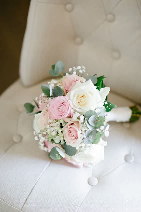 First dance  -  A soft, romantic bouquet designed to complement the magic of prom night. Featuring blush pink and creamy ivory roses, delicate baby’s breath, white hydrangeas, and fresh eucalyptus for a gentle touch of greenery. This hand-tied arrangement brings together timeless elegance and youthful charm—perfect for making a graceful entrance.  