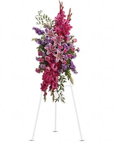 Tall pink and purple floral spray on a white stand