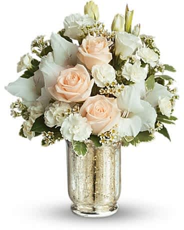 Peach roses and white flowers in a gold vase