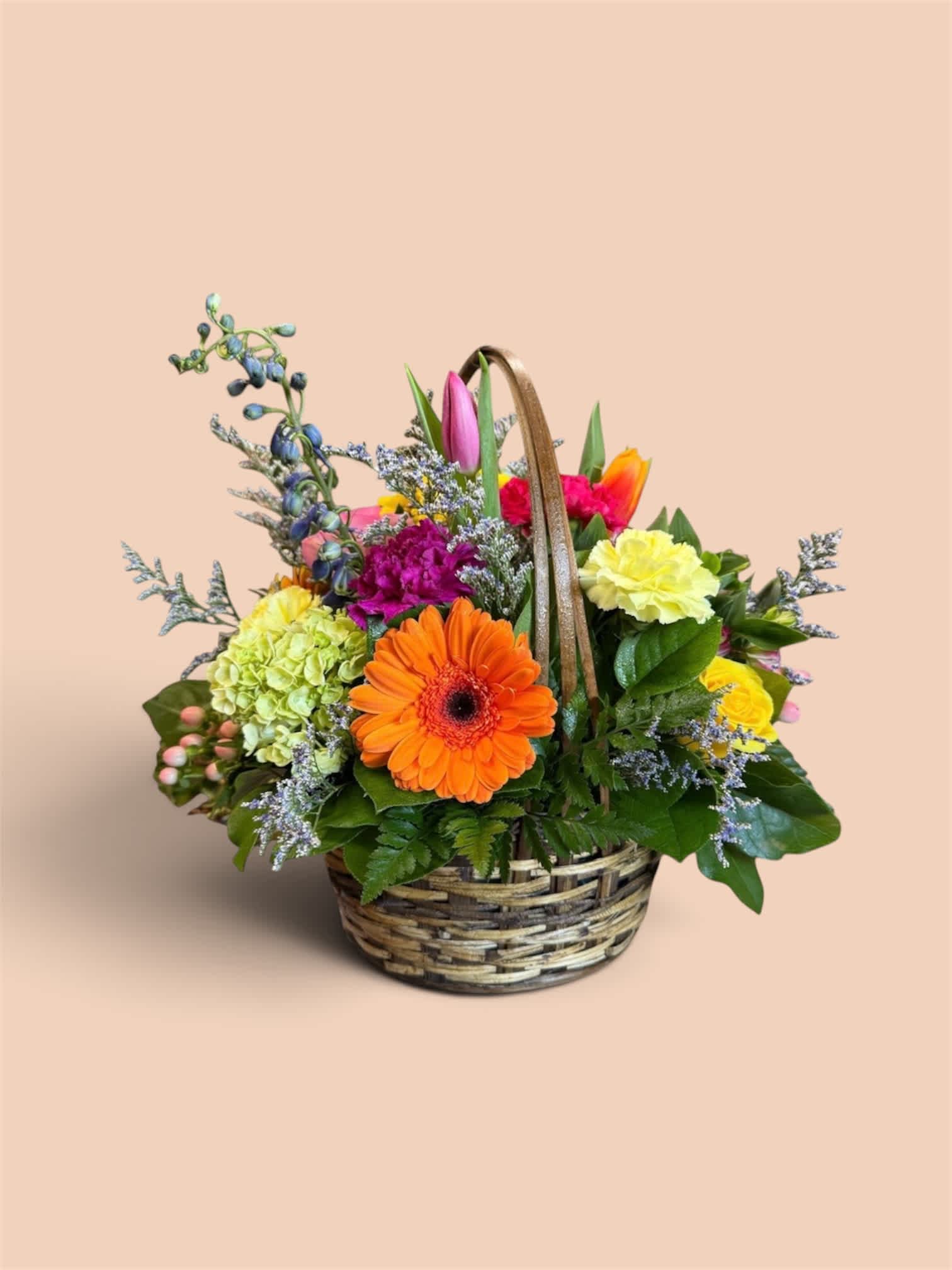 Mixed flower basket with an orange gerbera daisy and colorful blooms