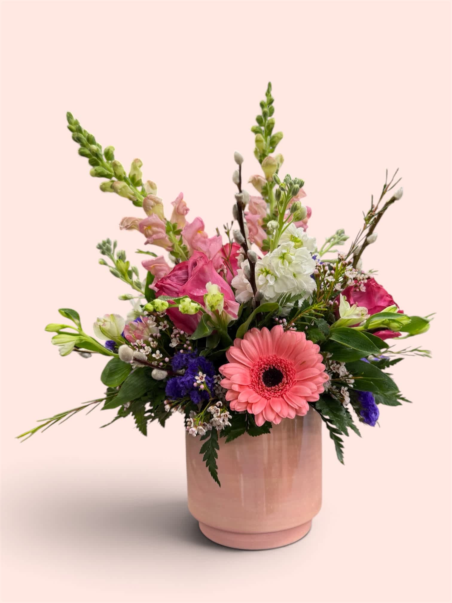 Pink and white mixed bouquet in a blush ceramic vase