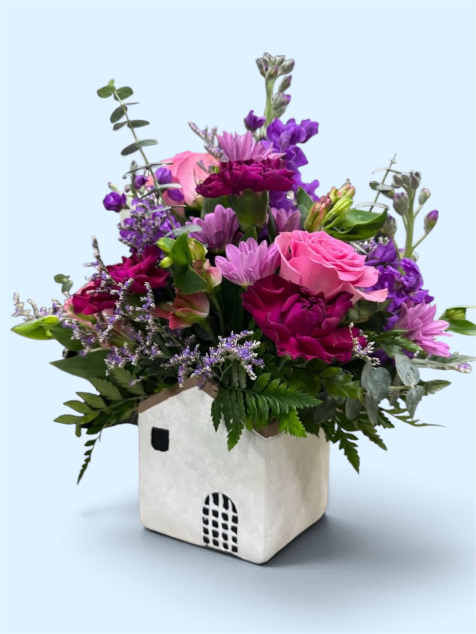 Pink and purple mixed bouquet in a white square container