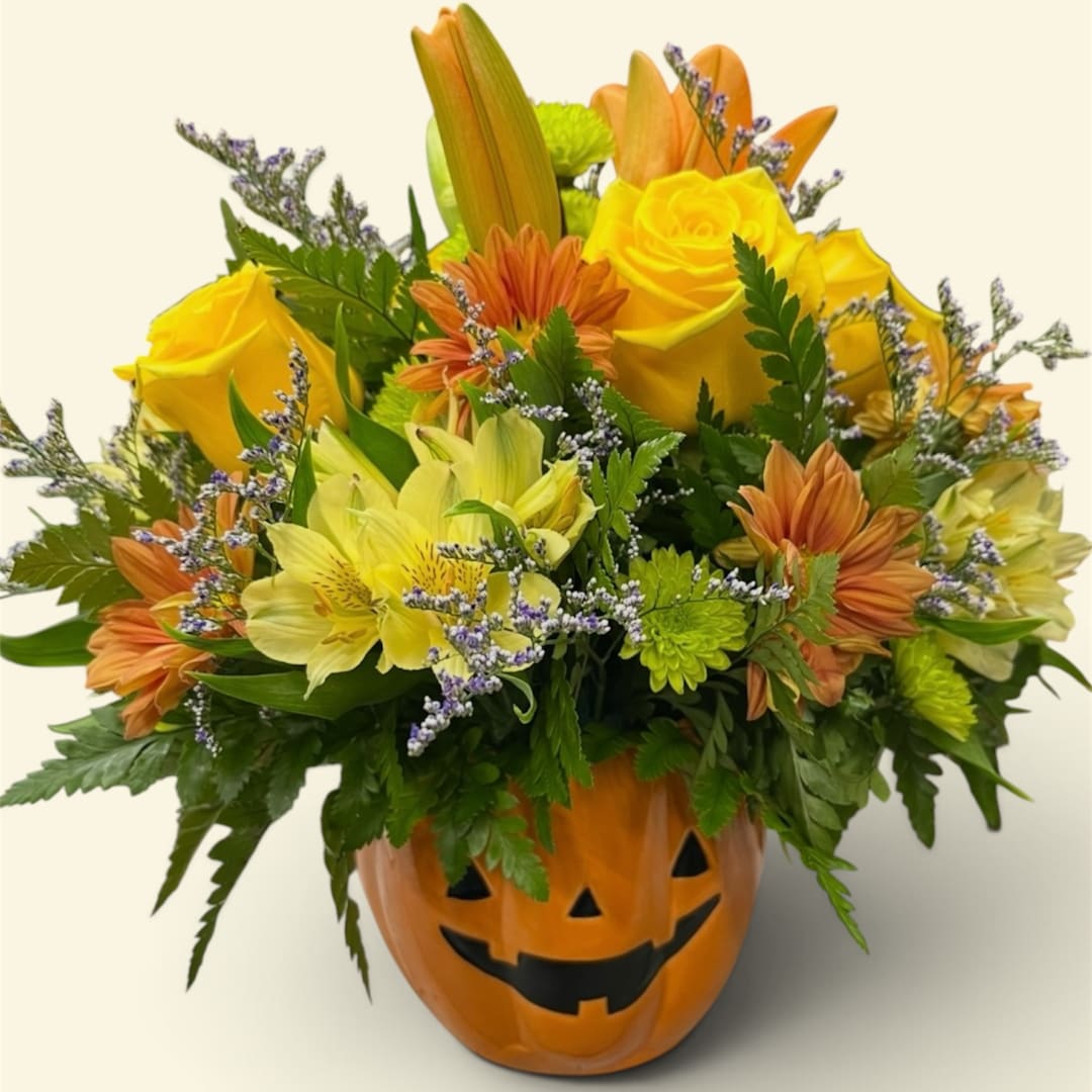 Yellow and orange mixed bouquet in a jack-o'-lantern pumpkin container