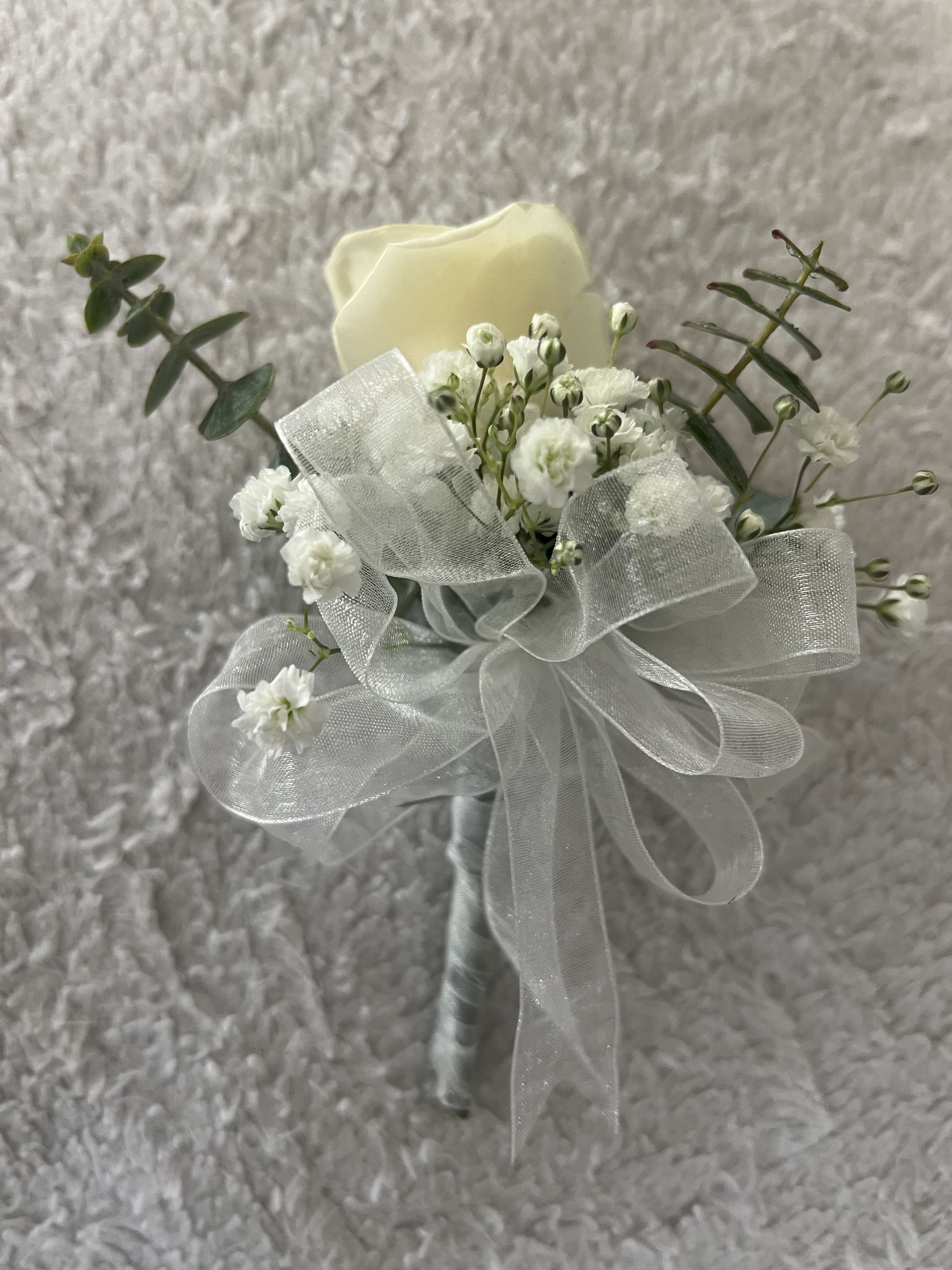 White Boutonniere  - Beautiful white rose that symbolizes purity. You can also choose the colors of the roses and the ribbon according to the occasion
