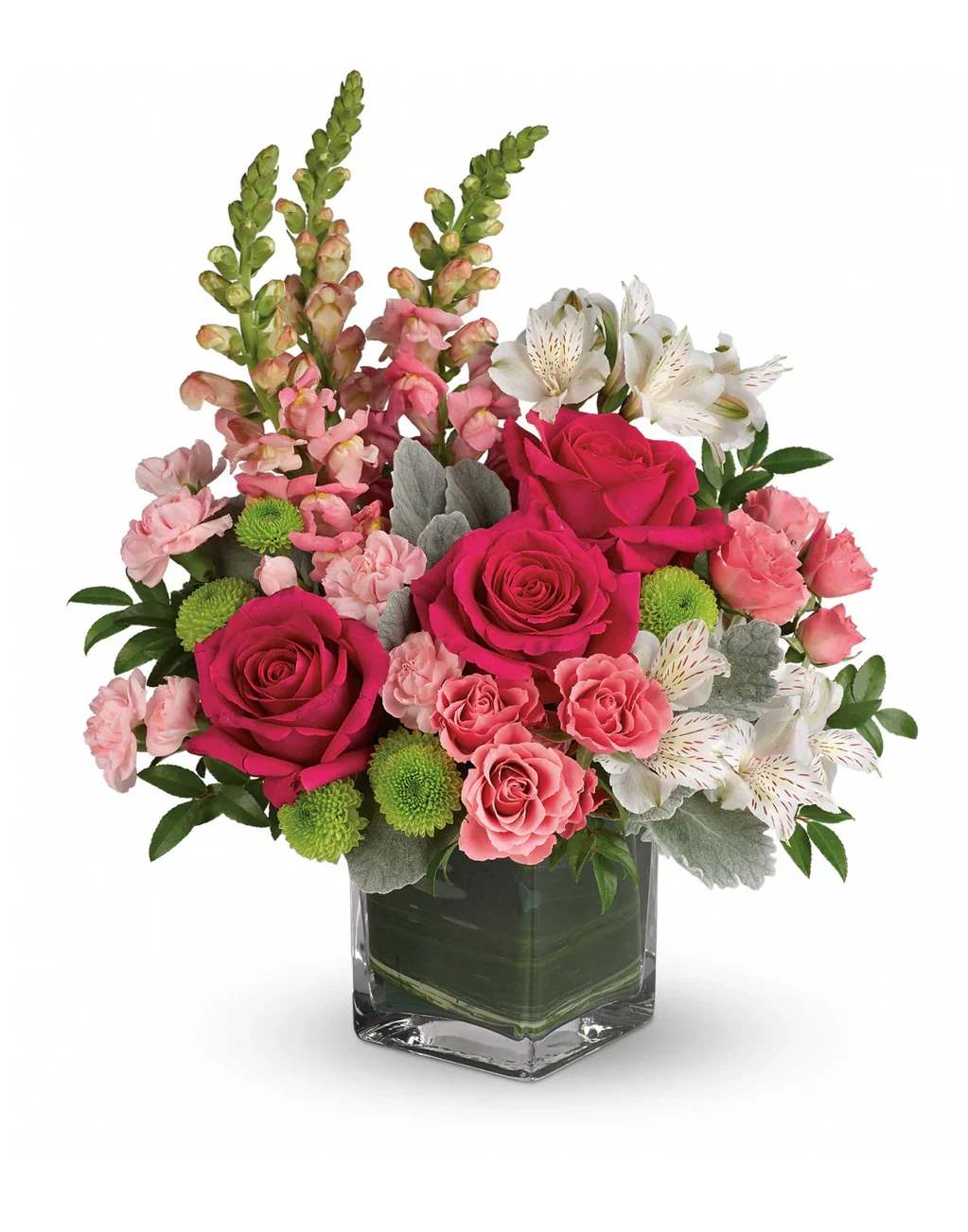 Pink roses and mixed blooms arranged in a clear square vase