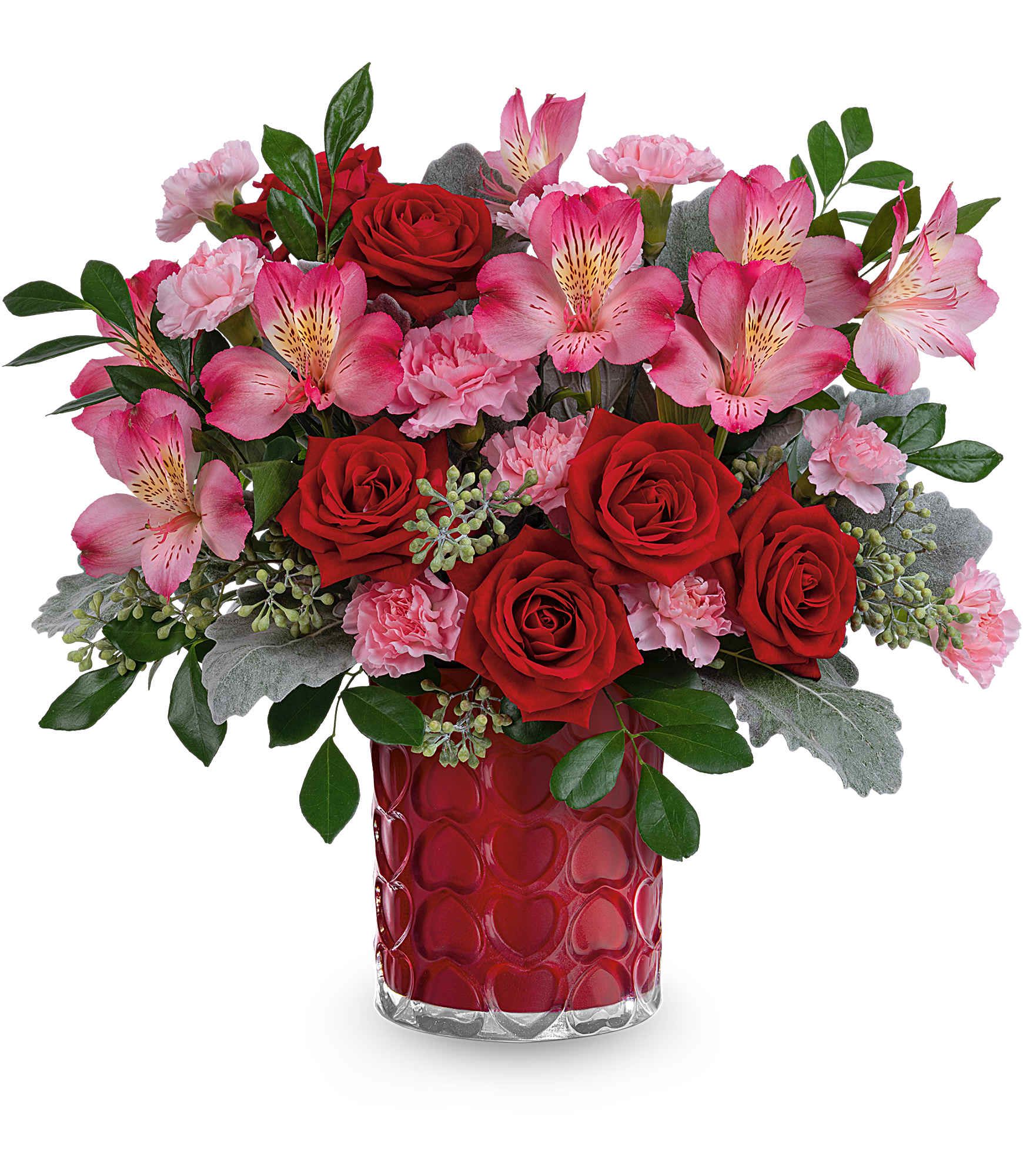 Red roses and pink flowers in a red heart-pattern vase
