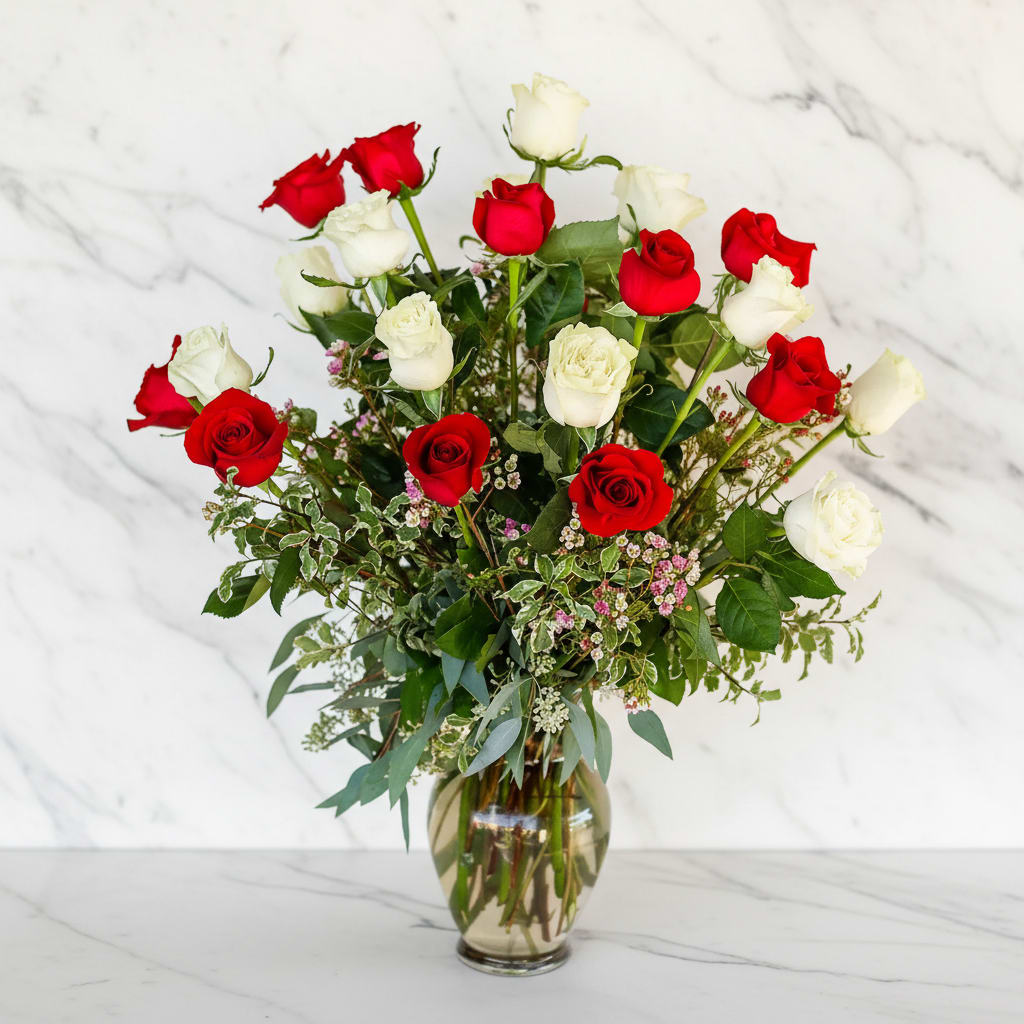 Red and white roses in a glass vase