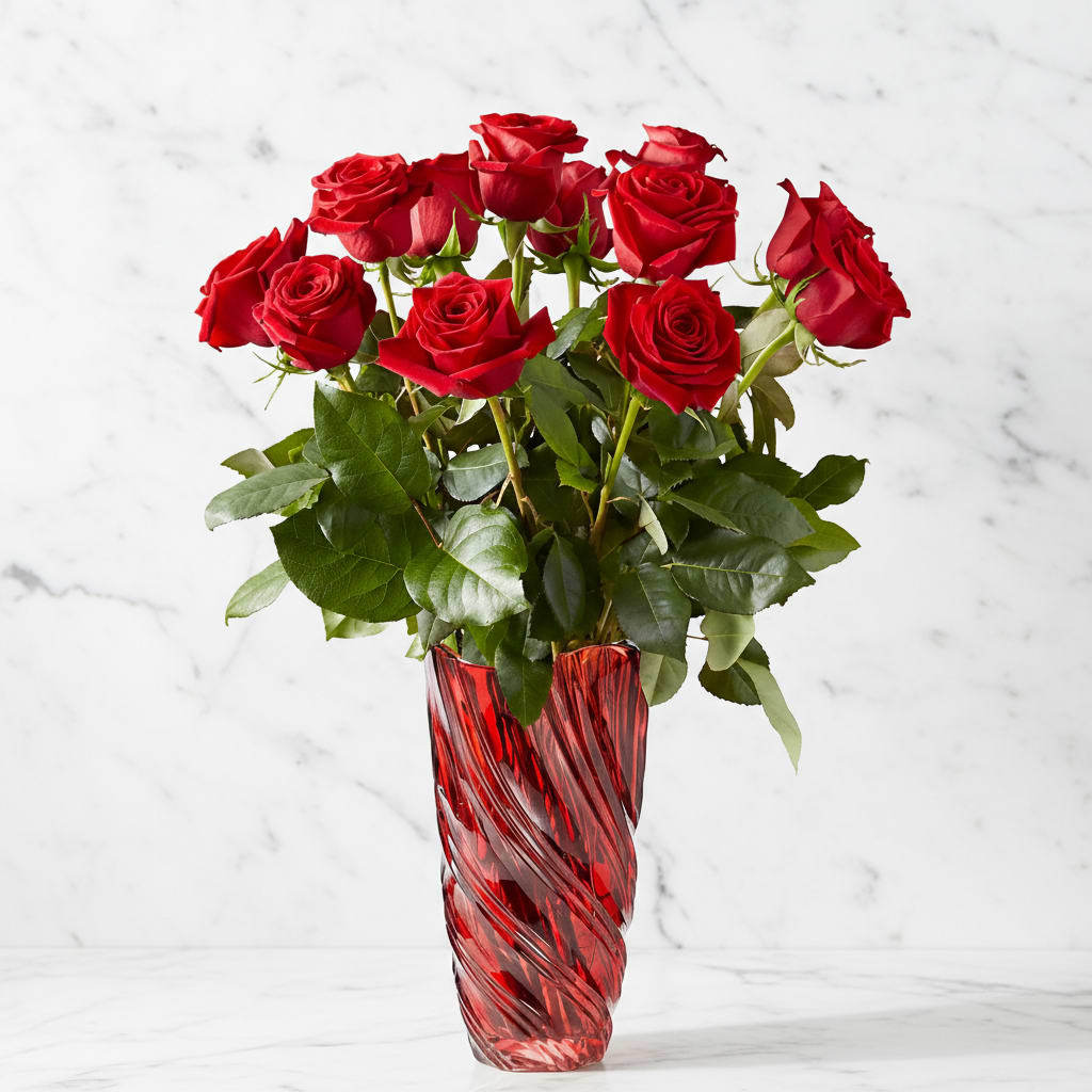 Red roses arranged in a tall red glass vase