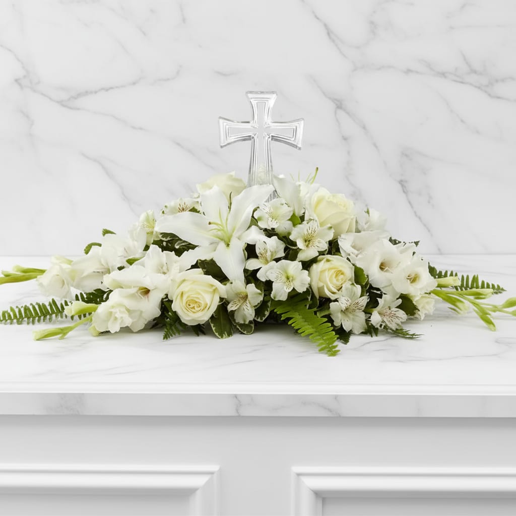 White floral arrangement with a clear cross centerpiece