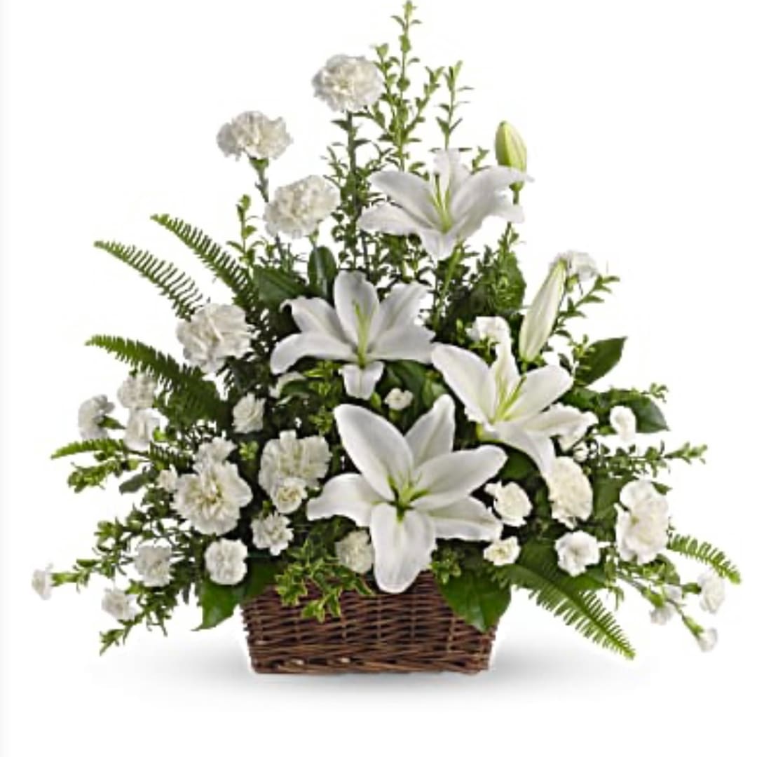 White lilies and carnations in a wicker basket