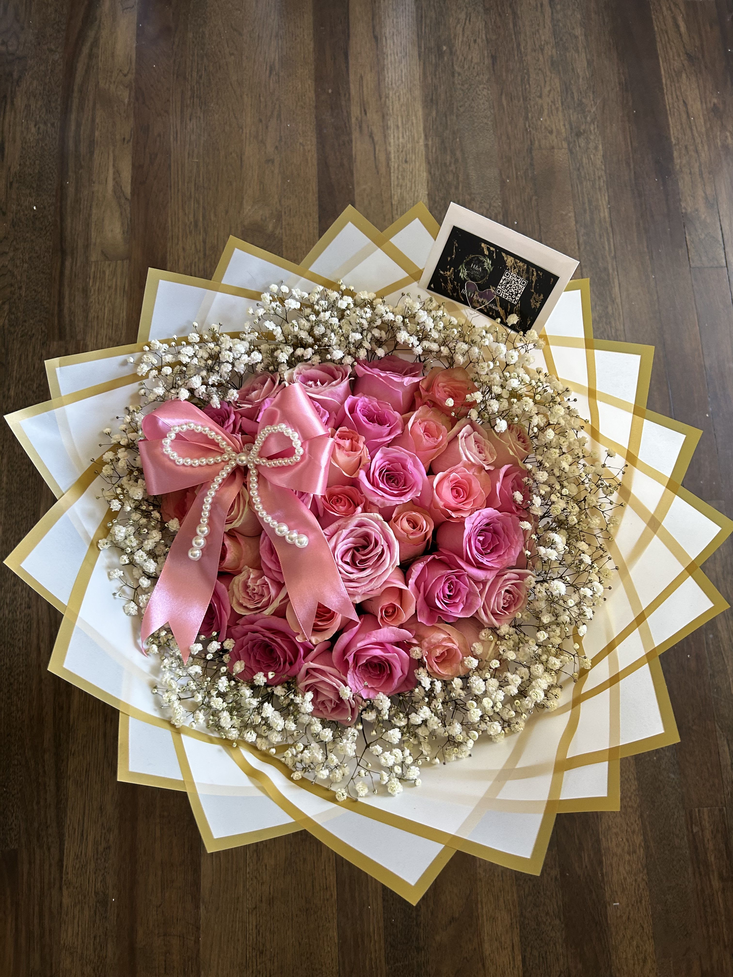 Pink rose bouquet with baby's breath and a satin bow