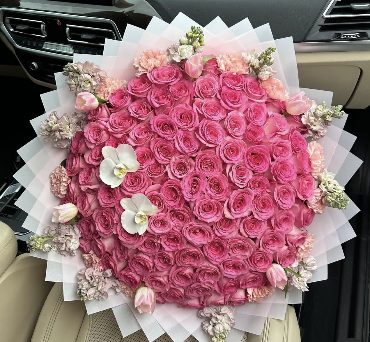 Large bouquet of pink roses with white orchids and tulips