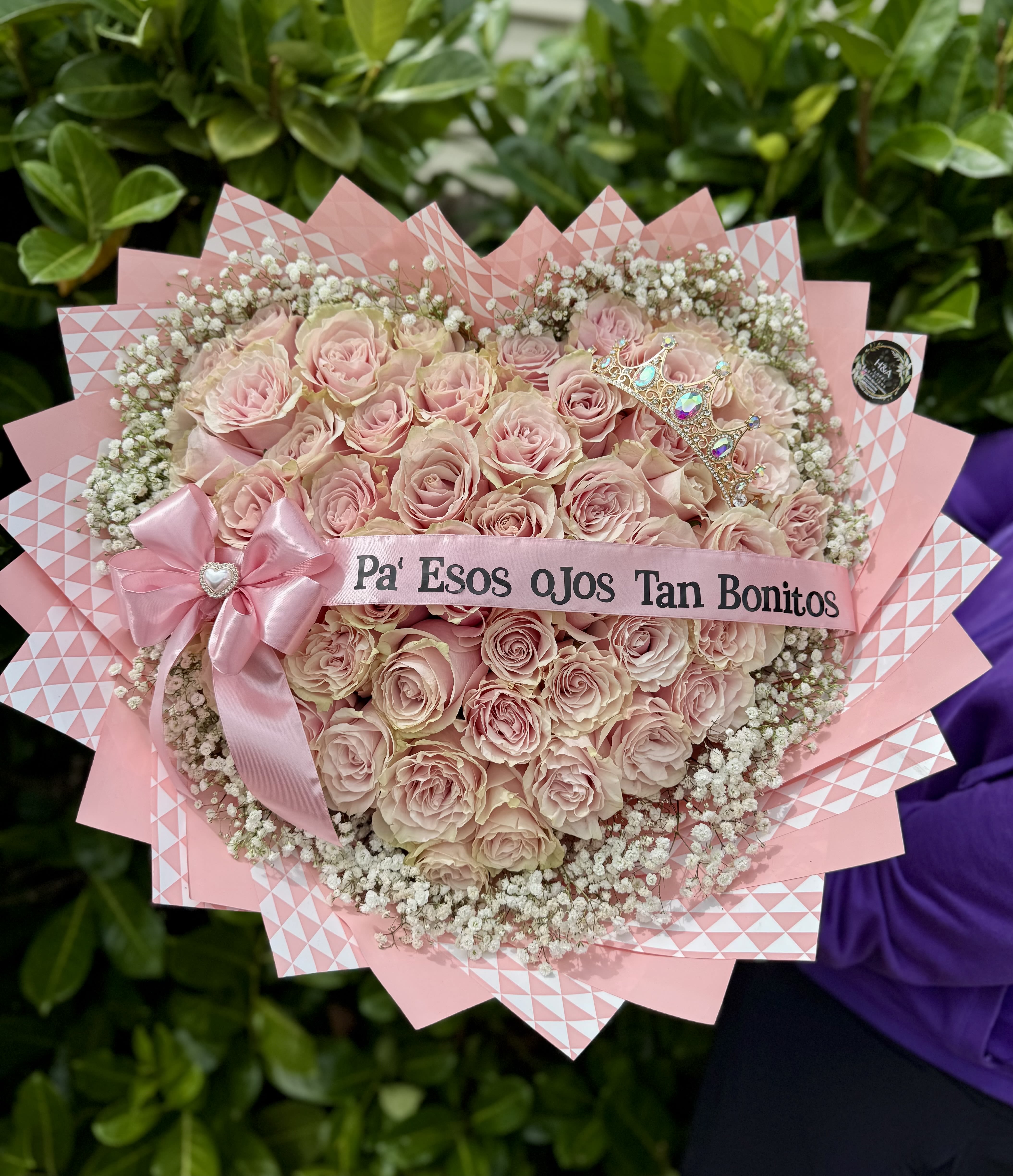 Pink rose bouquet with a ribbon and decorative crown