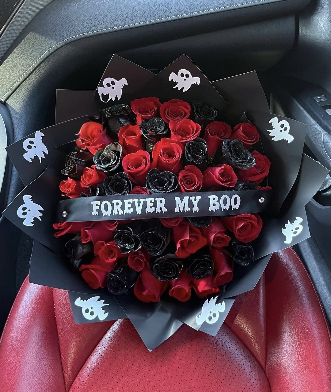 Bouquet of red and black roses with ghost decorations and a "FOREVER MY BOO" ribbon