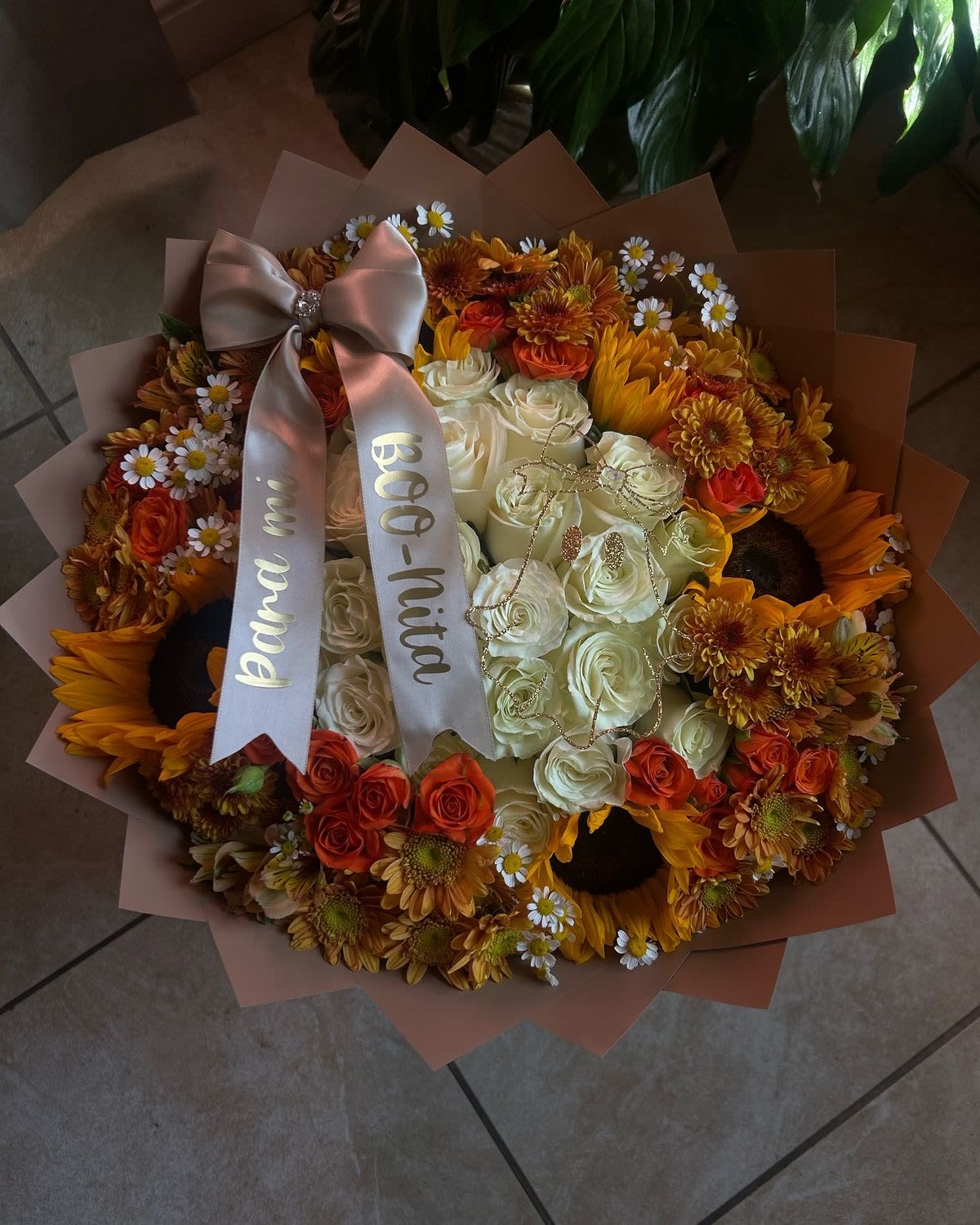 Bouquet of white and orange roses with sunflowers and daisies