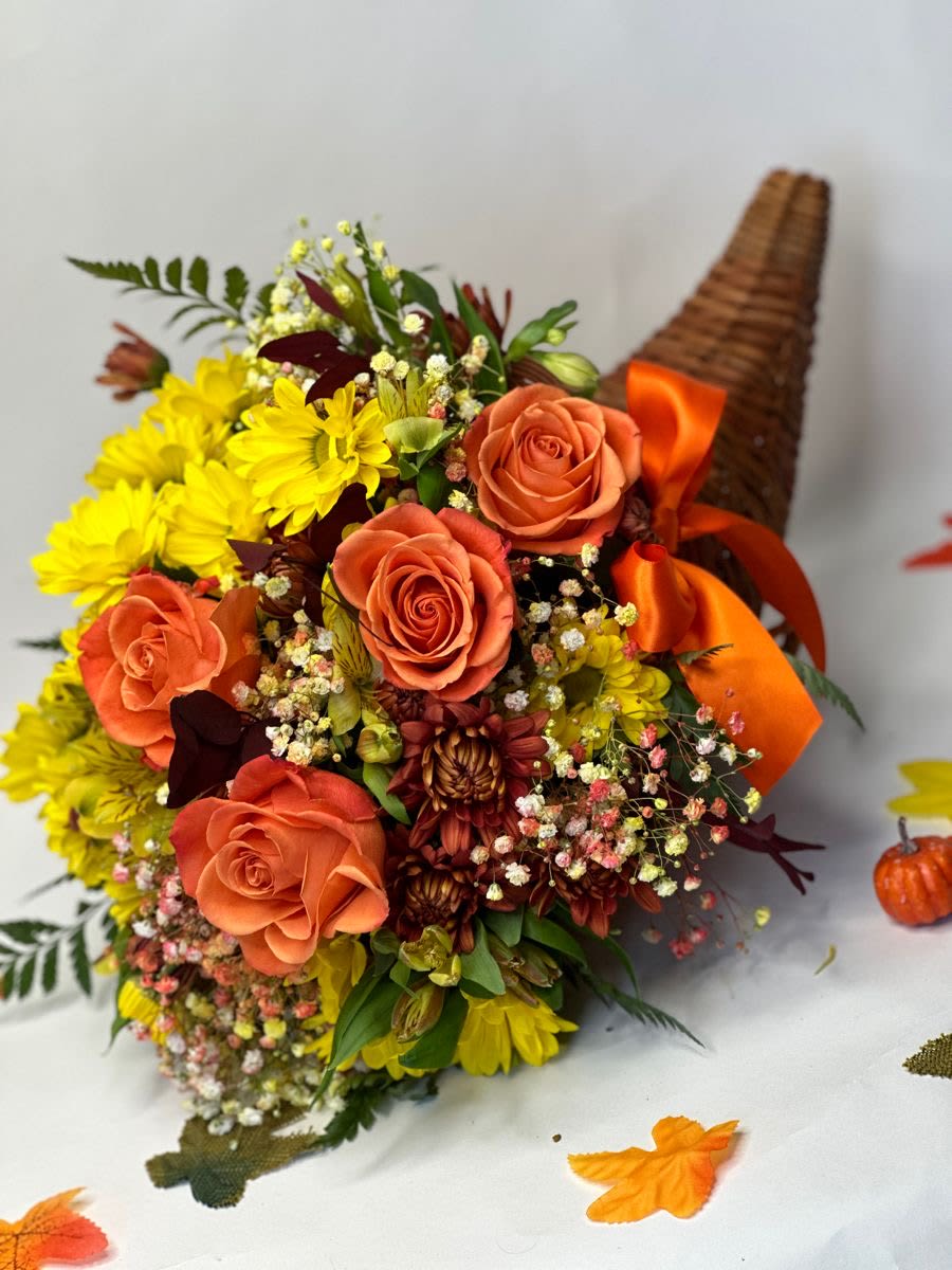 Orange roses and yellow daisies in a wicker cone with ribbon