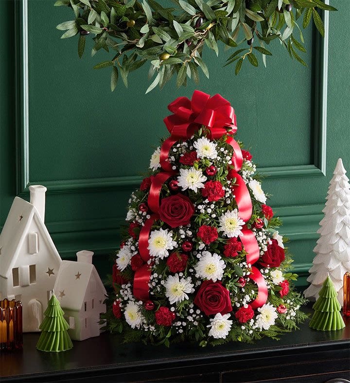 Cone-shaped floral arrangement with red ribbon and white daisies