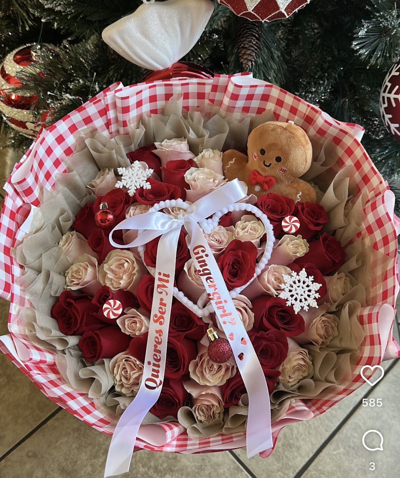 Bouquet of red and blush roses with a gingerbread plush and holiday ornaments